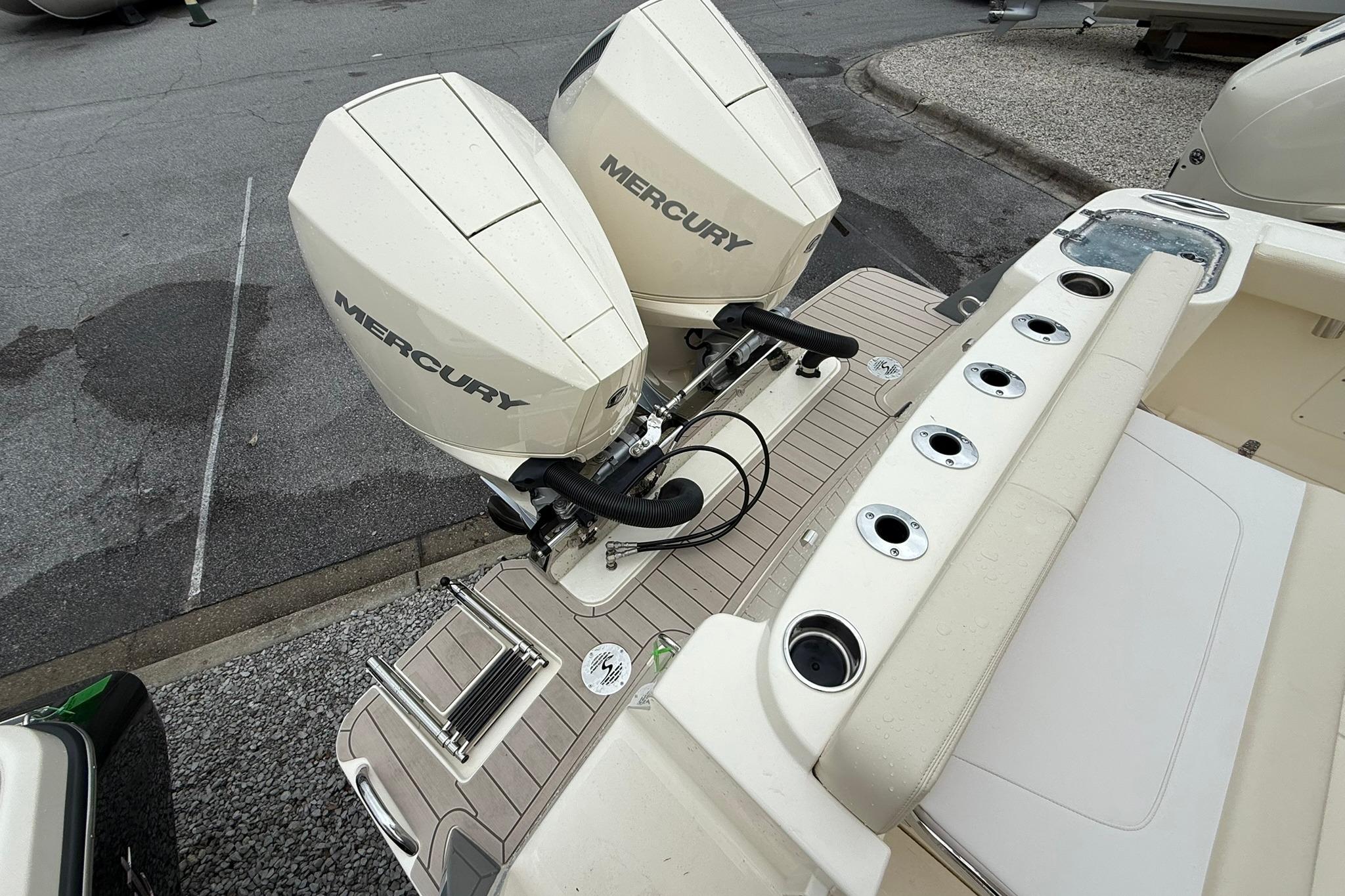 2026 Scout 260 LXF boat with dual Mercury outboard engines and rod holders.