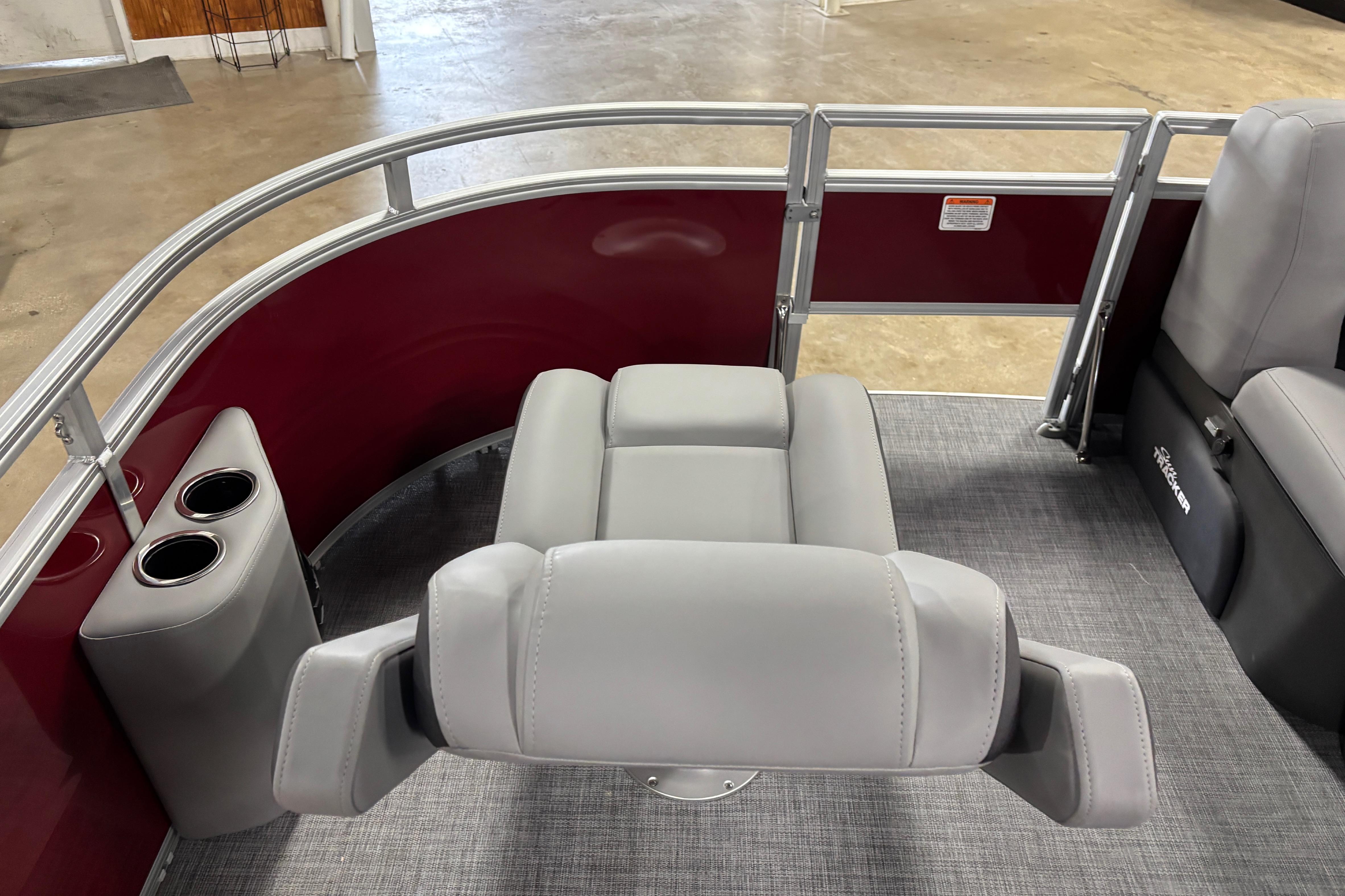 2026 Sun Tracker SportFish 20 DLX boat interior with gray seating and cup holders.