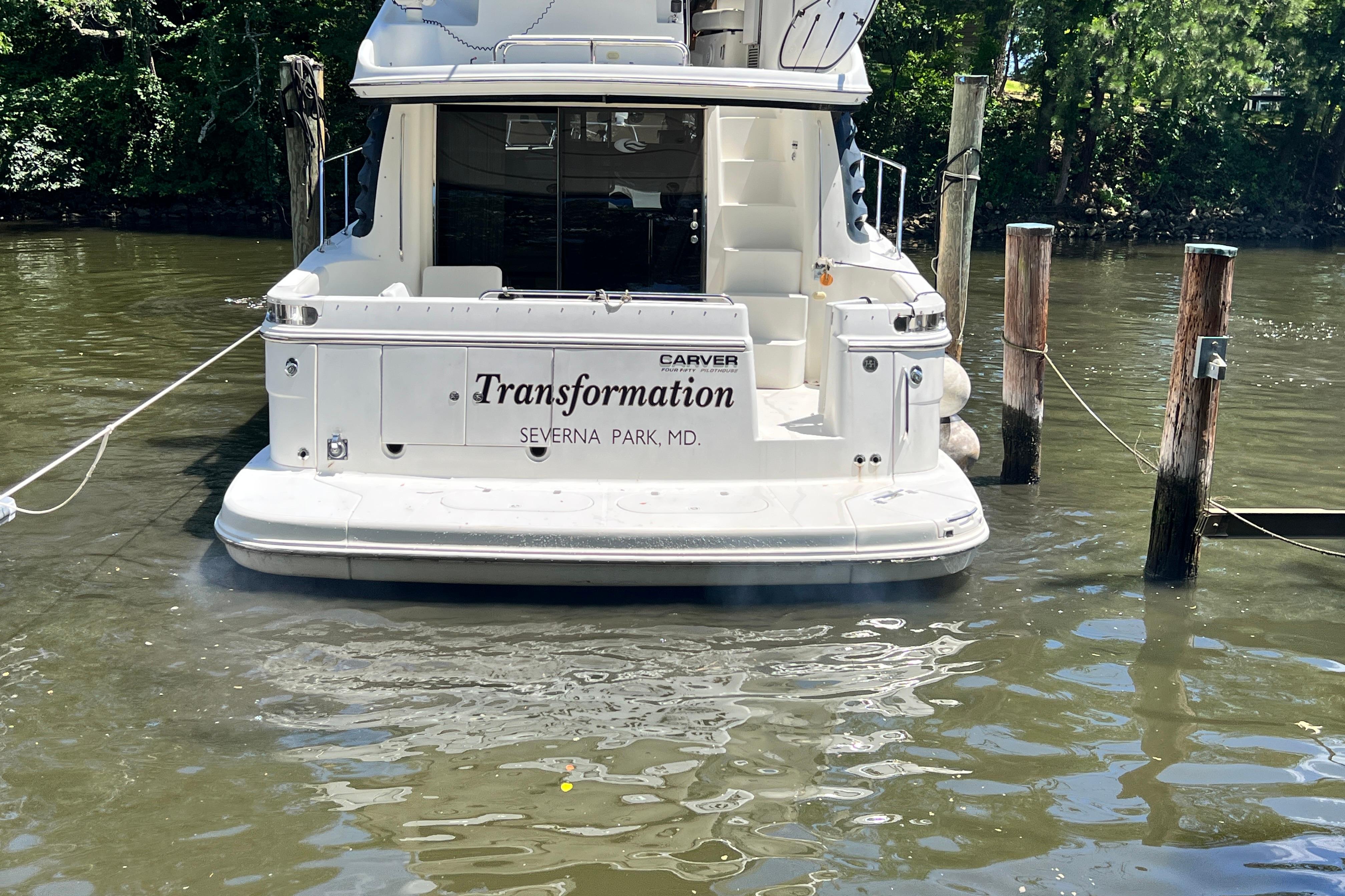 2003 Carver 450 Voyager Pilothouse docked, rear view, named "Transformation," Severna Park, MD.