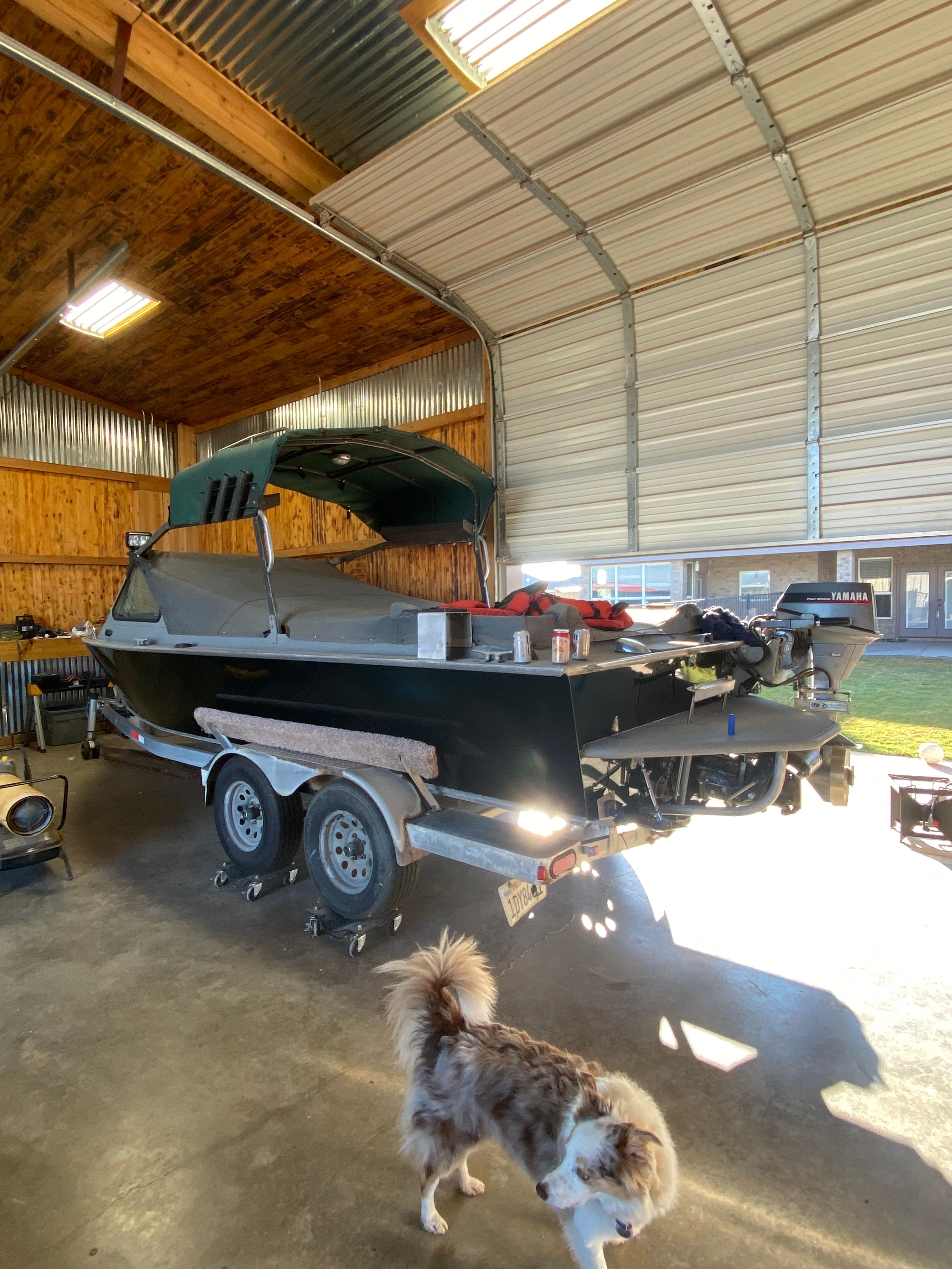 1993 Jetcraft Fastwater boat in garage with dog.