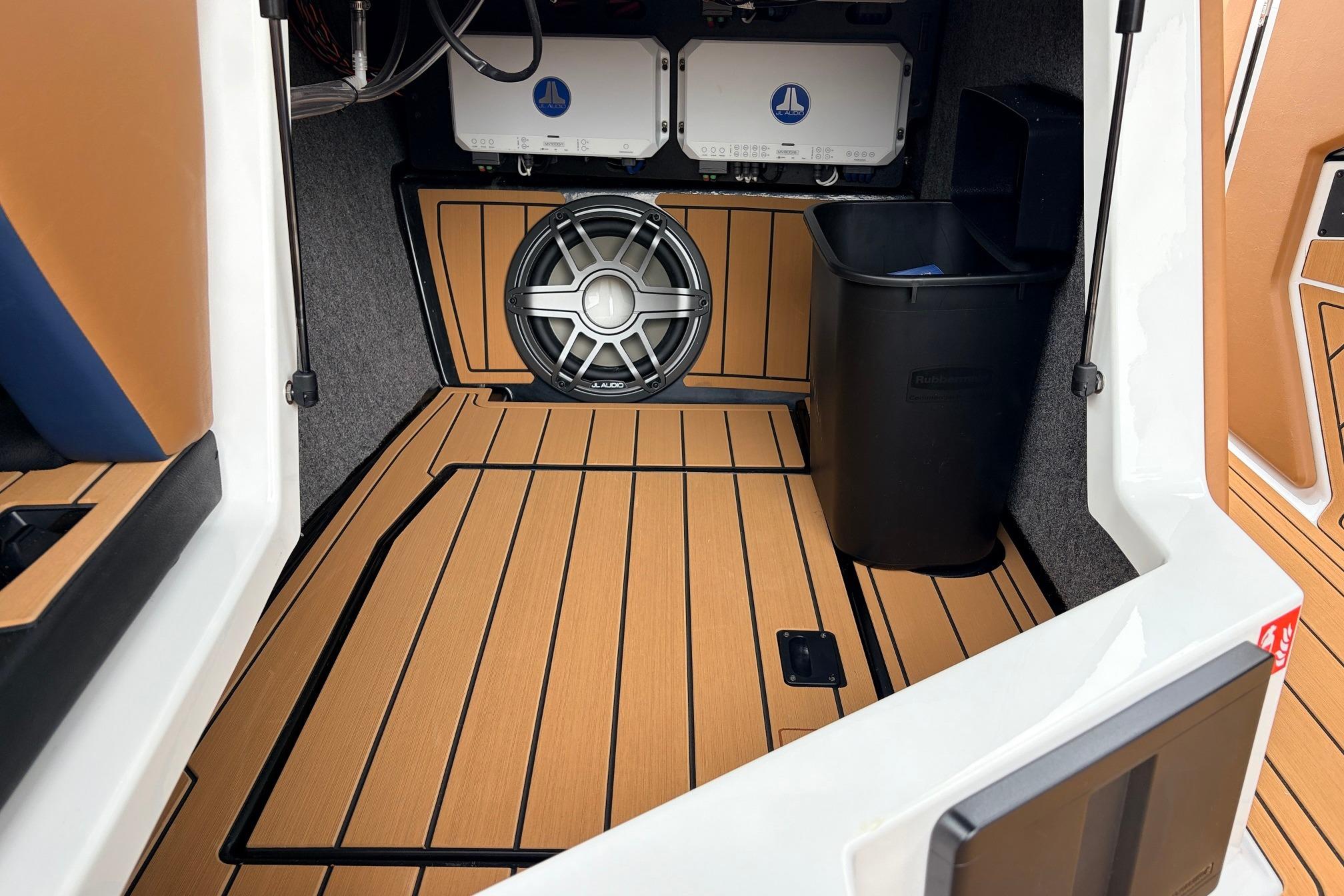 2026 Nautique Super Air Nautique G25 interior with premium audio system and teak flooring.