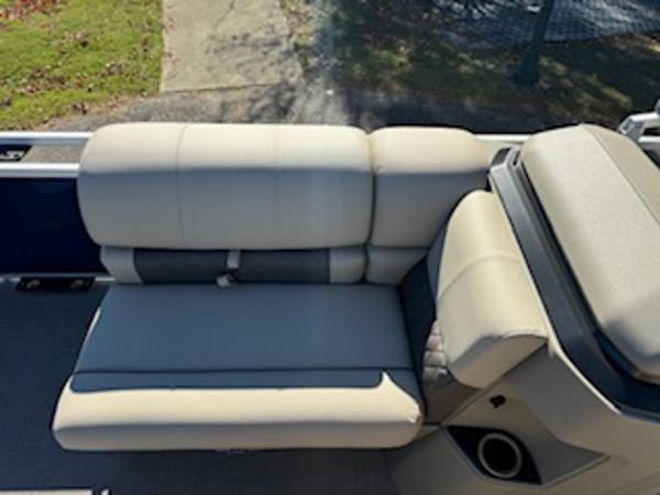 Interior of 2025 Sun Tracker Fishin' Barge 22 DLX with beige seating.