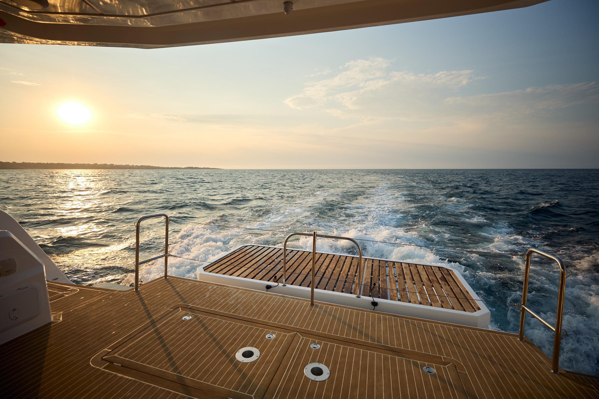 Sunset view from 2025 Omaya 50 Power Catamaran deck, cruising on open sea.