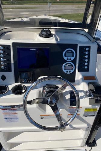 2024 Robalo R222 Center Console boat dashboard with steering wheel and navigation controls.