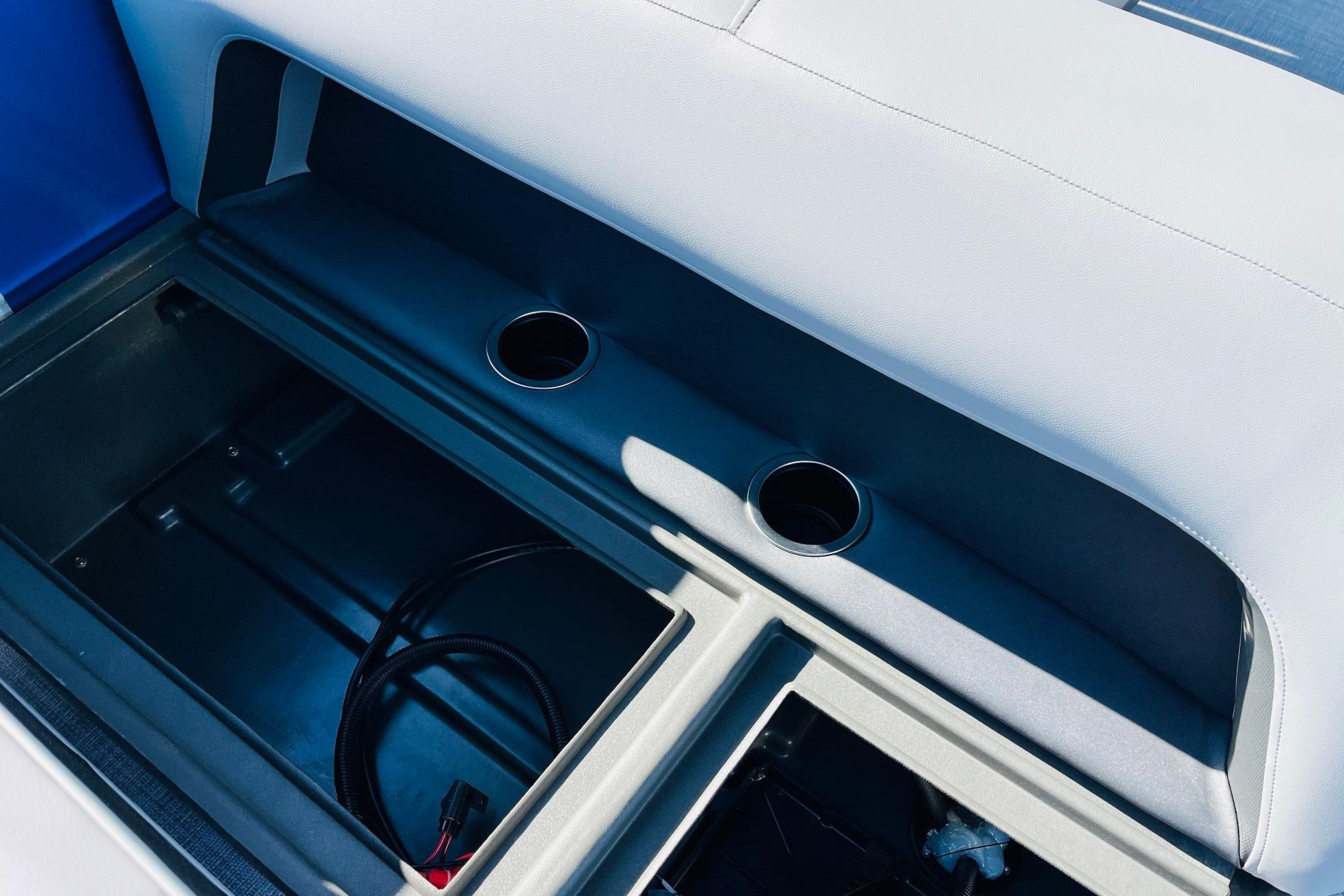 2026 Sun Tracker Party Barge 18 DLX storage compartment with cup holders.