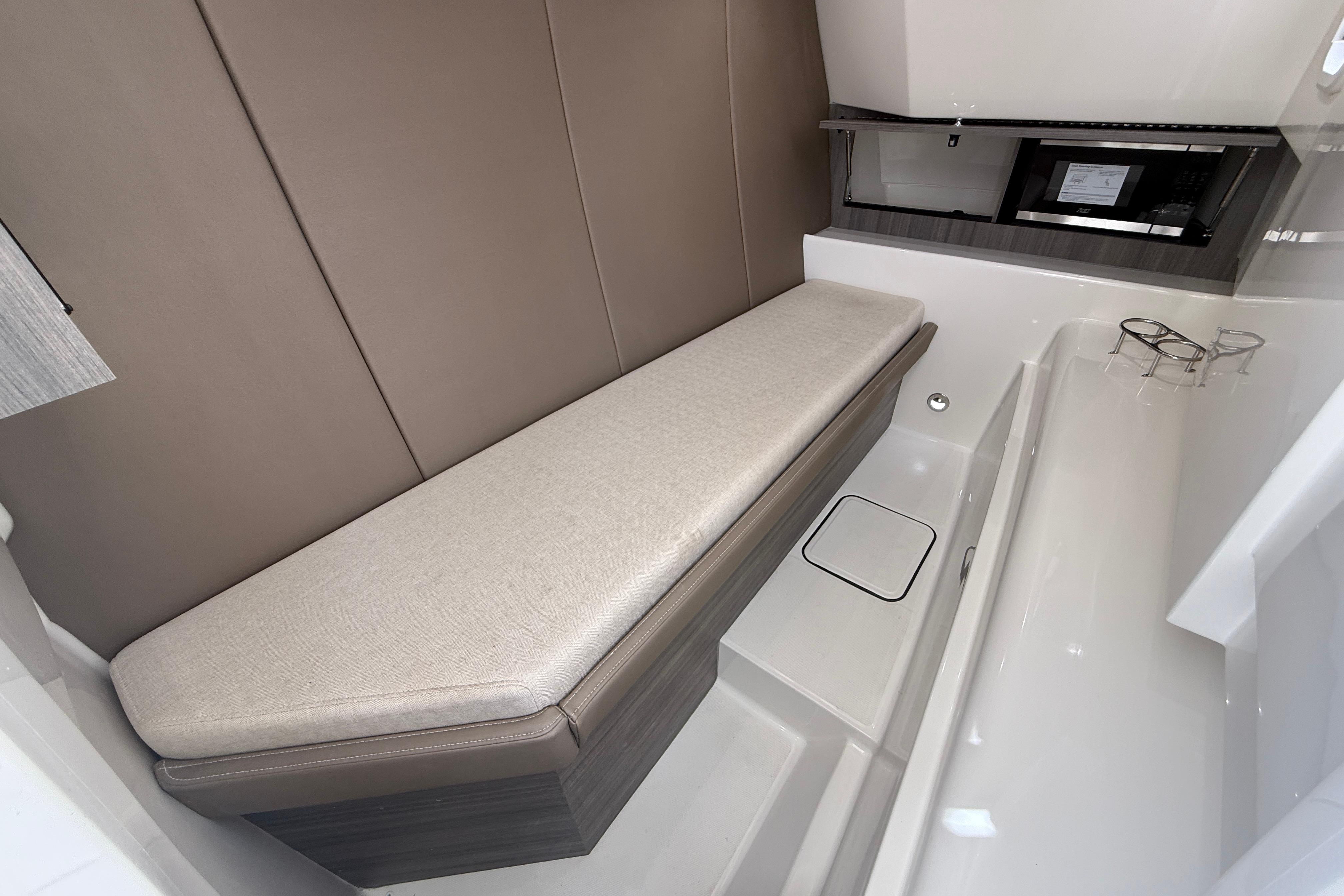 Interior of 2026 World Cat 400 DC-X Island boat, featuring a cushioned bench and modern amenities.