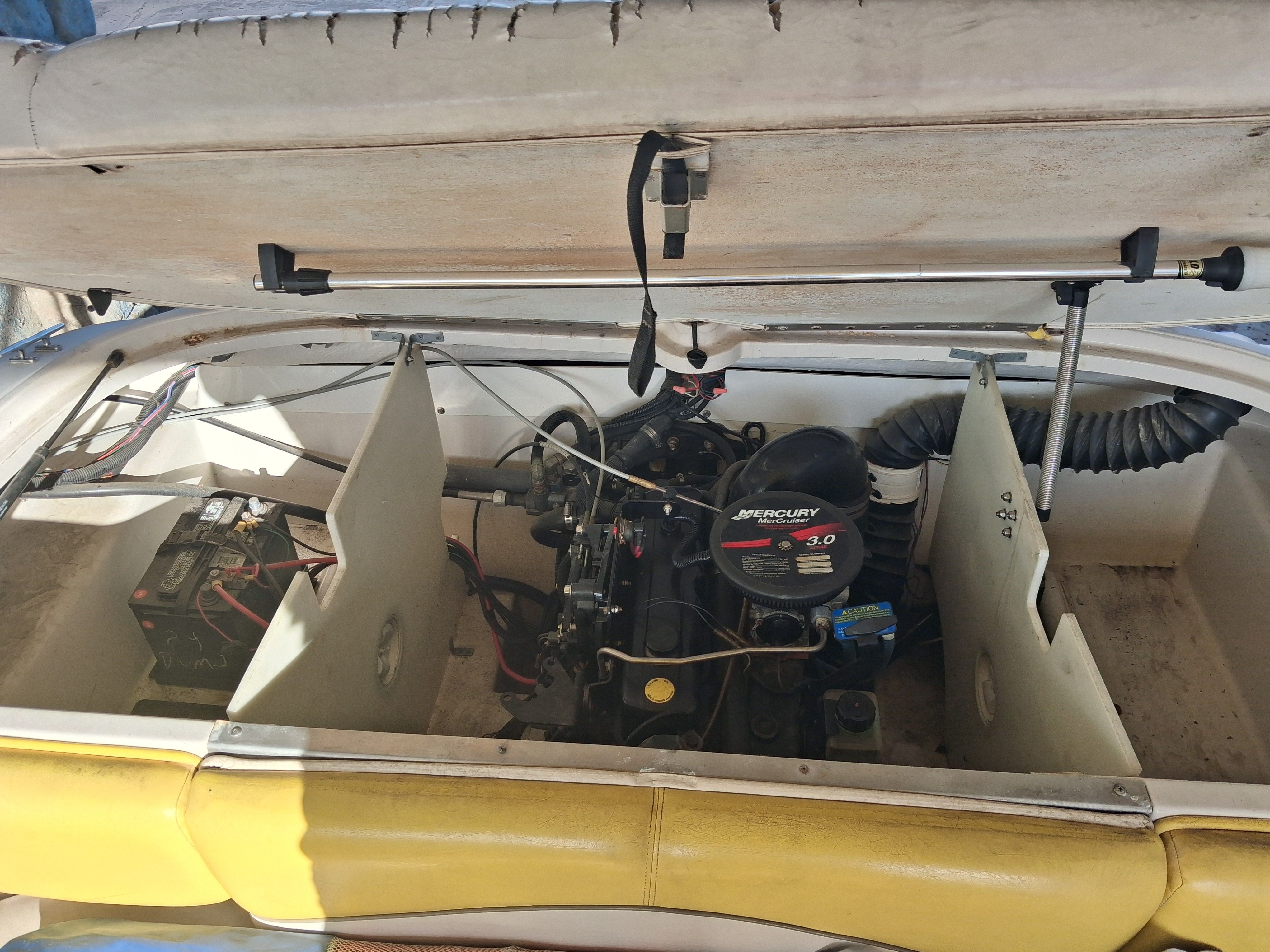 2004 Tracker Tahoe boat engine with open compartment.