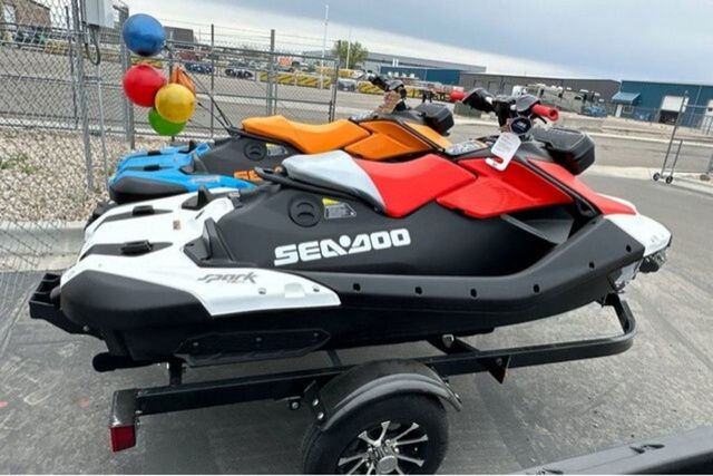 A Sea-Doo PWC SPARK TRIXX 90 on a trailer, surrounded by colorful balloons.