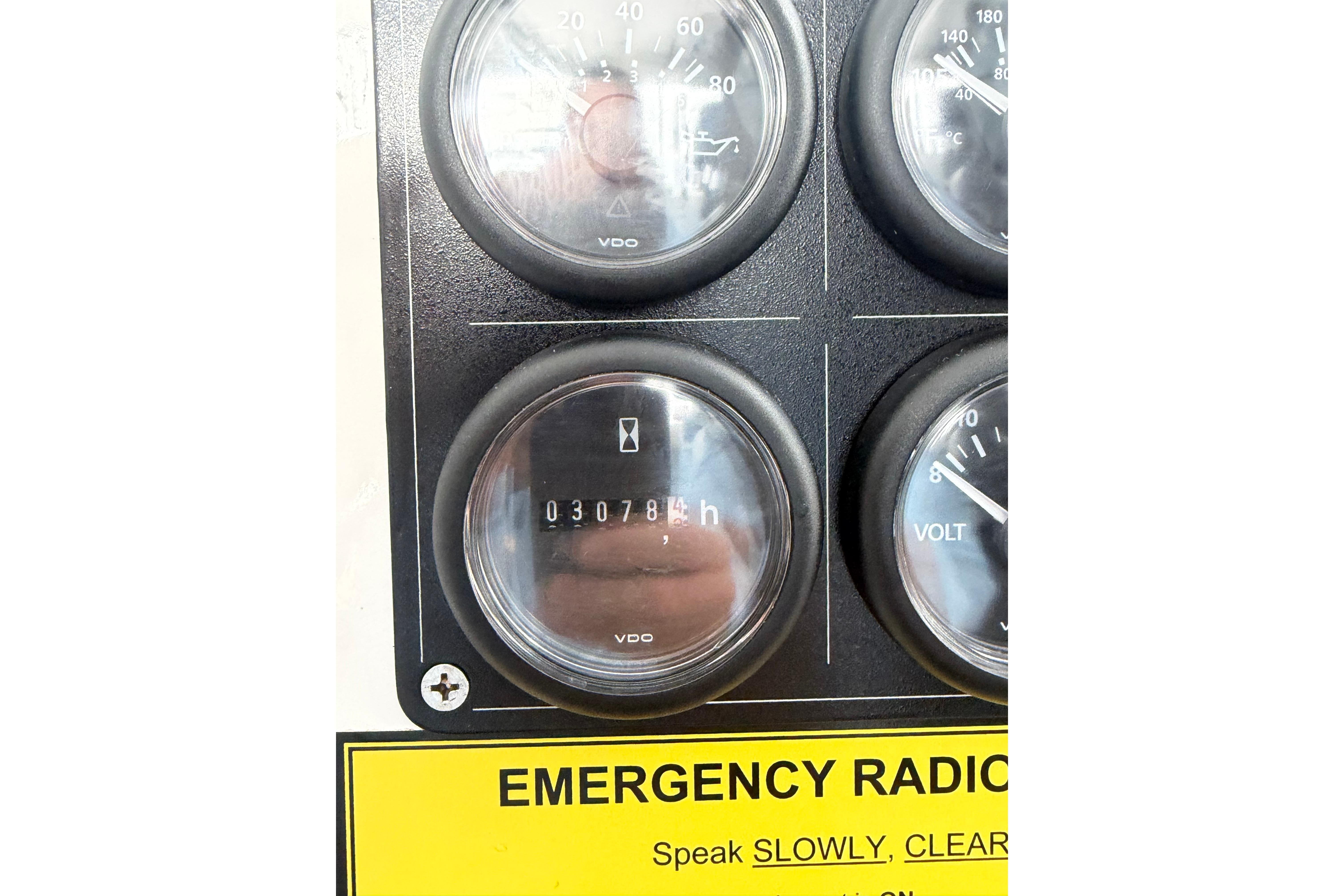 Dashboard gauges of 2018 H&H Marine Osmond Beal boat, showing engine hours and emergency radio instructions.