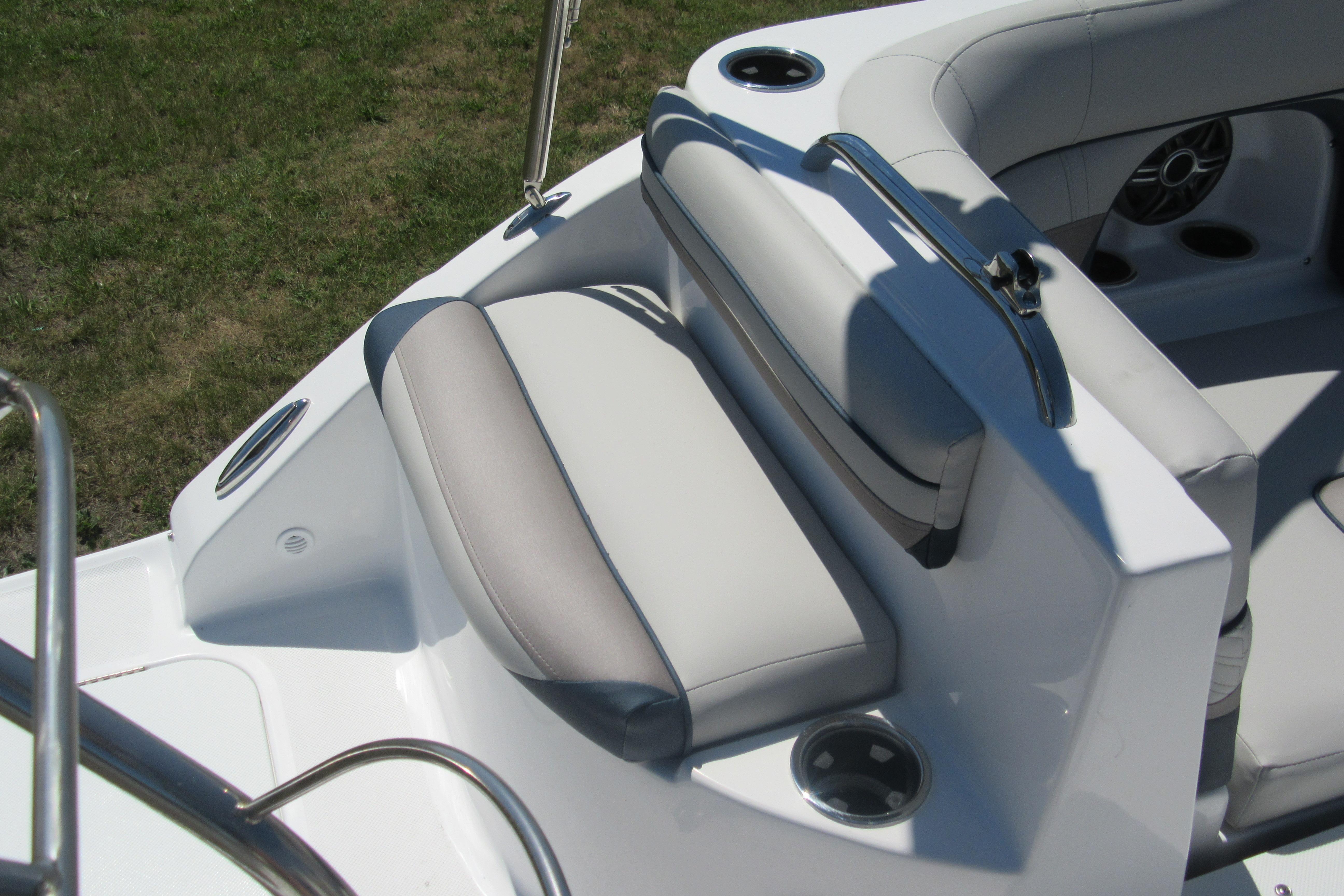 2027 Hurricane SunDeck 2486 OB boat seating area with cup holders and sleek design.