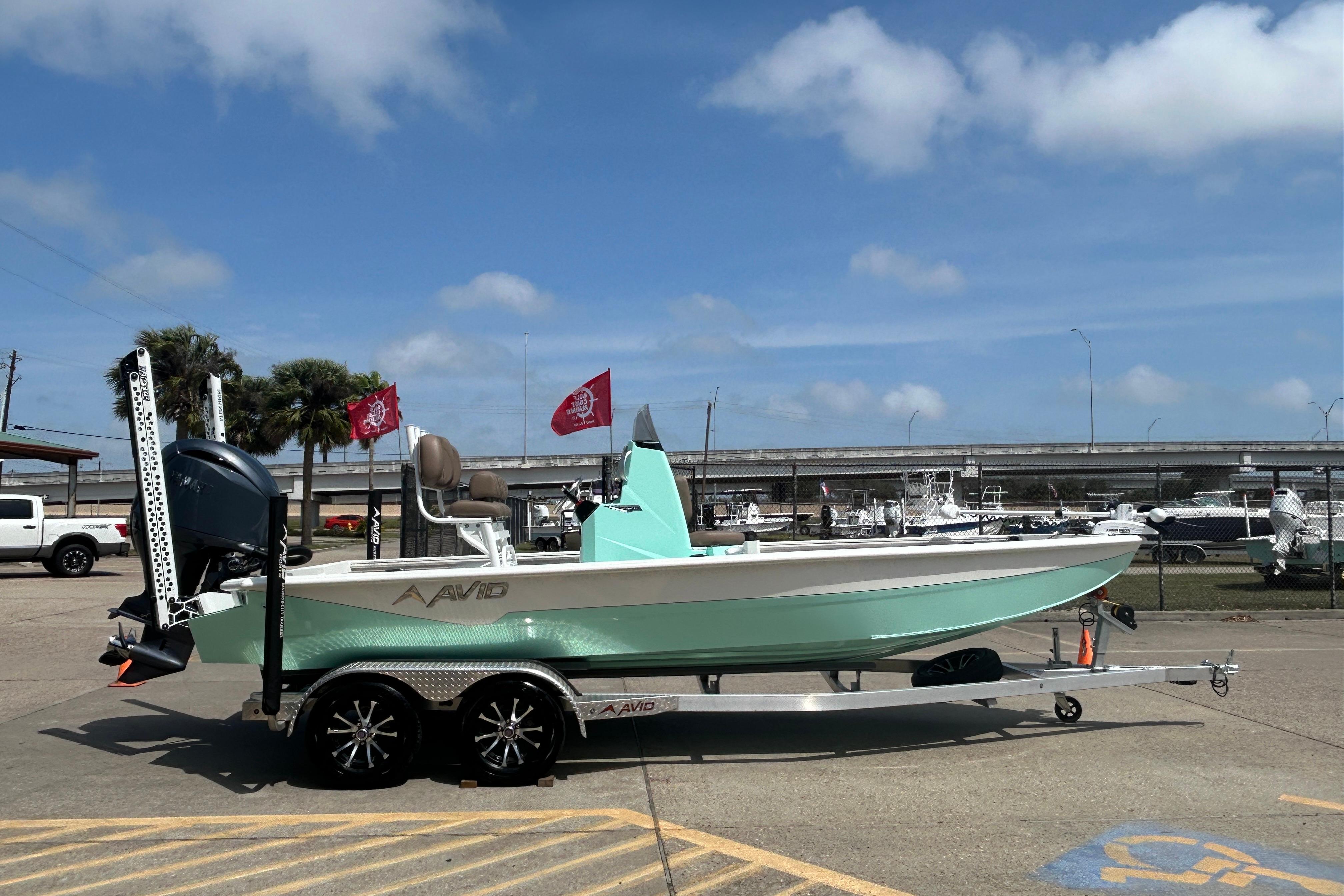 Avid 21 Mag 2026 boat on trailer, parked outdoors under blue sky.