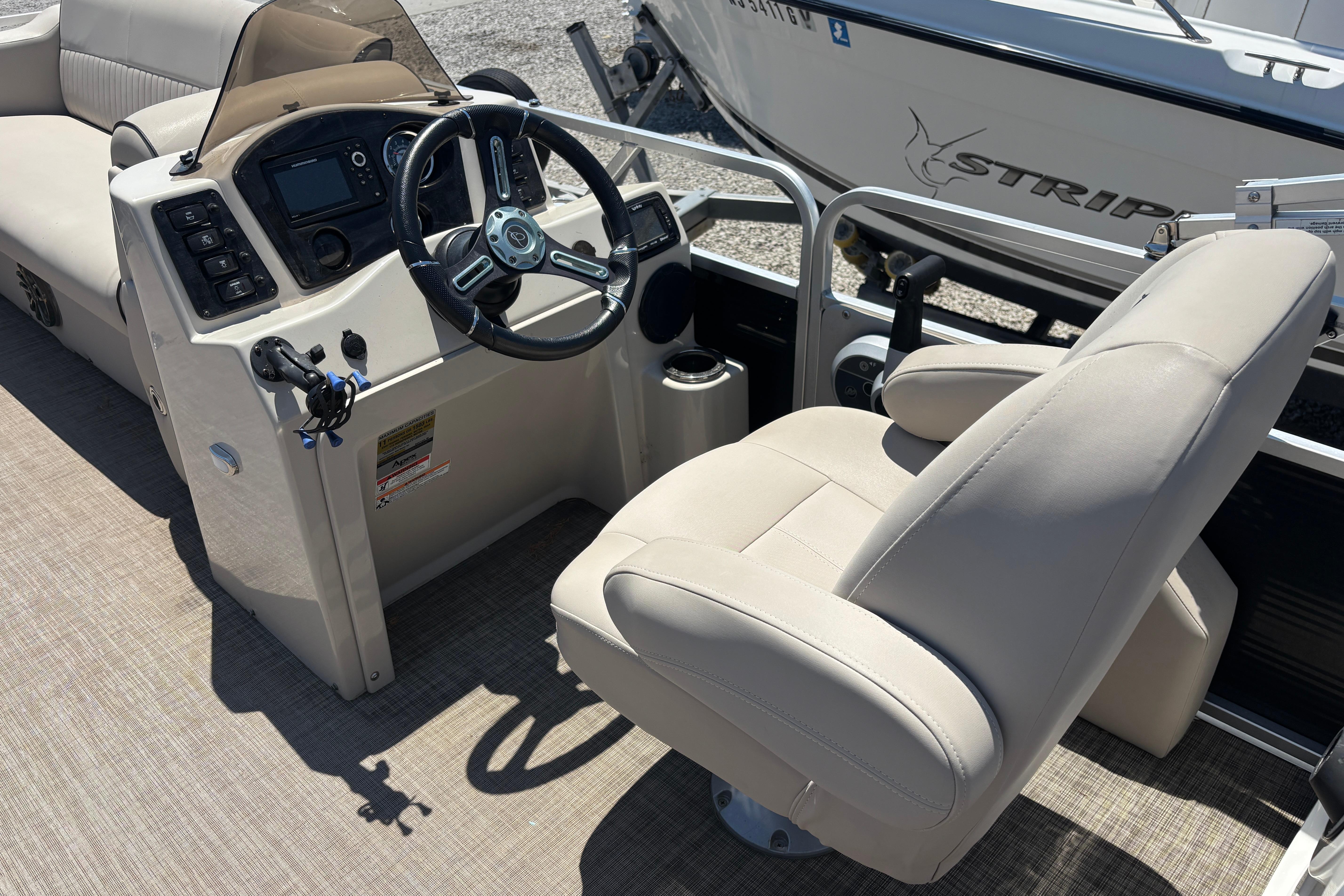 2017 Qwest LS 822 Bar boat interior with steering console and comfortable seating.