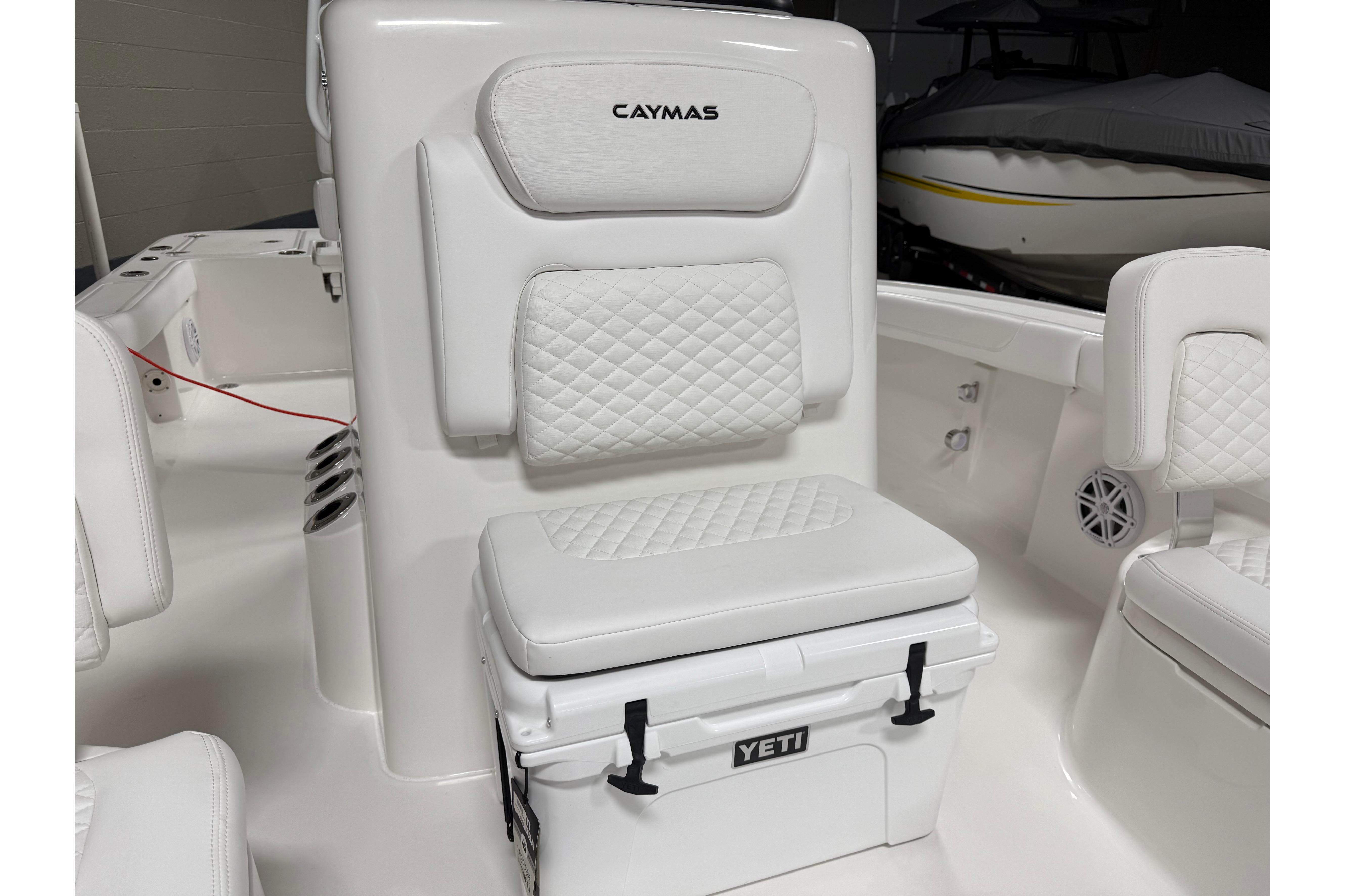 2026 Caymas 24 HB boat interior with white cushioned seating and Yeti cooler.