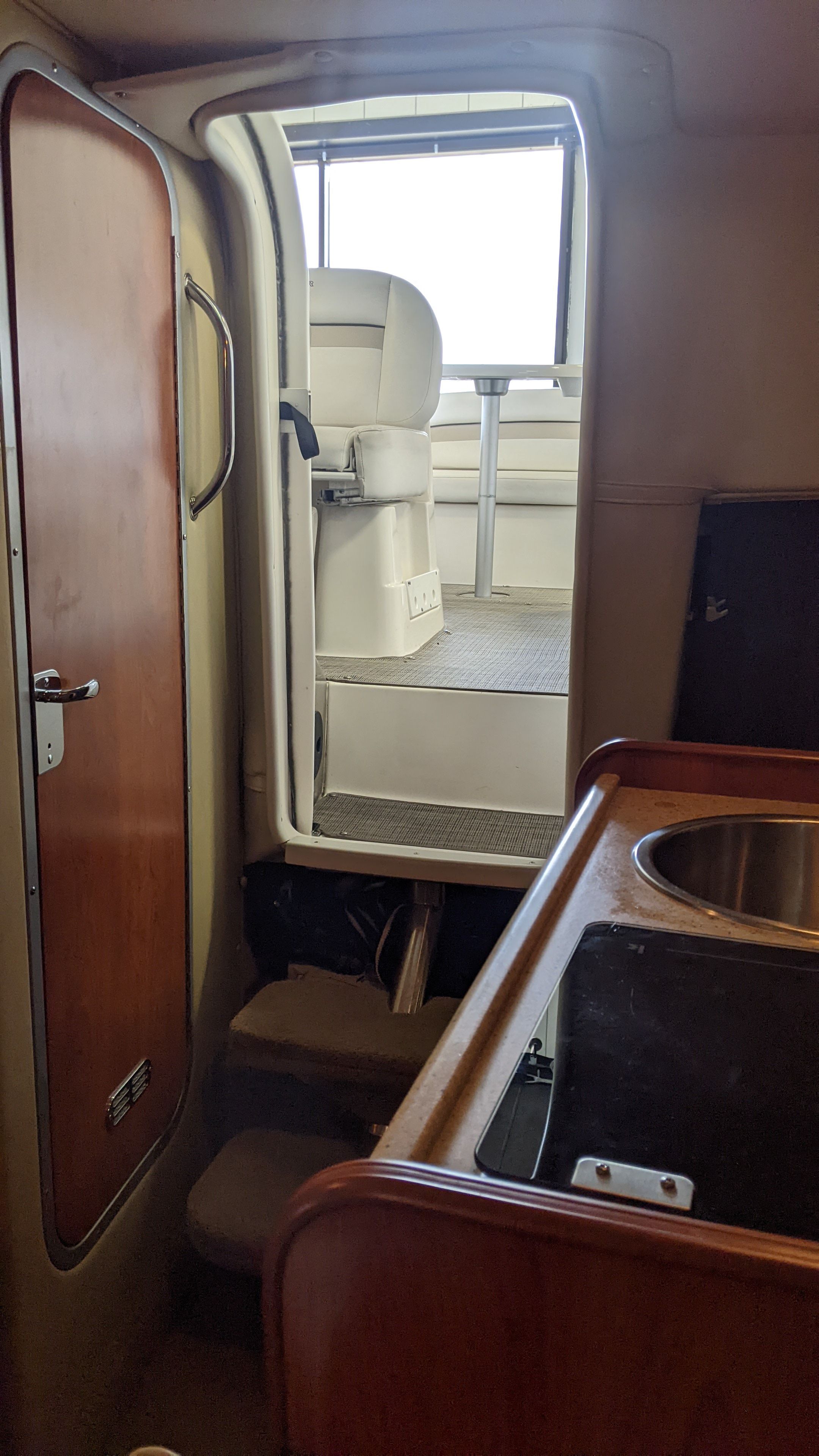 Interior of a 2006 Rinker 250 EC yacht with kitchen and cockpit.