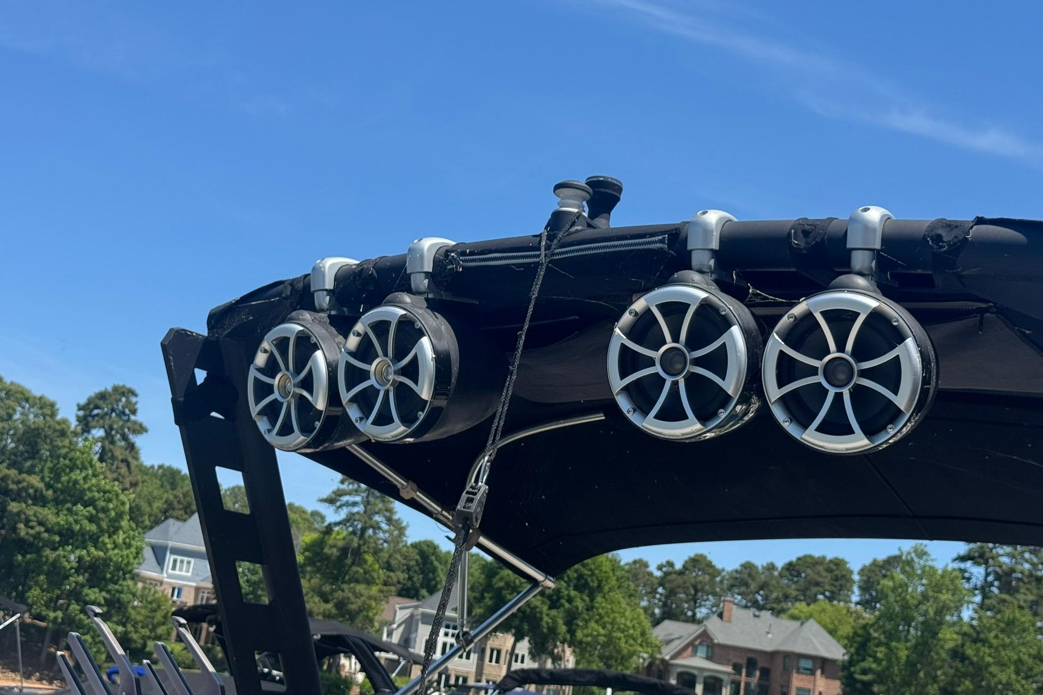 Speakers mounted on a 2017 Axis T23 boat against a clear blue sky.