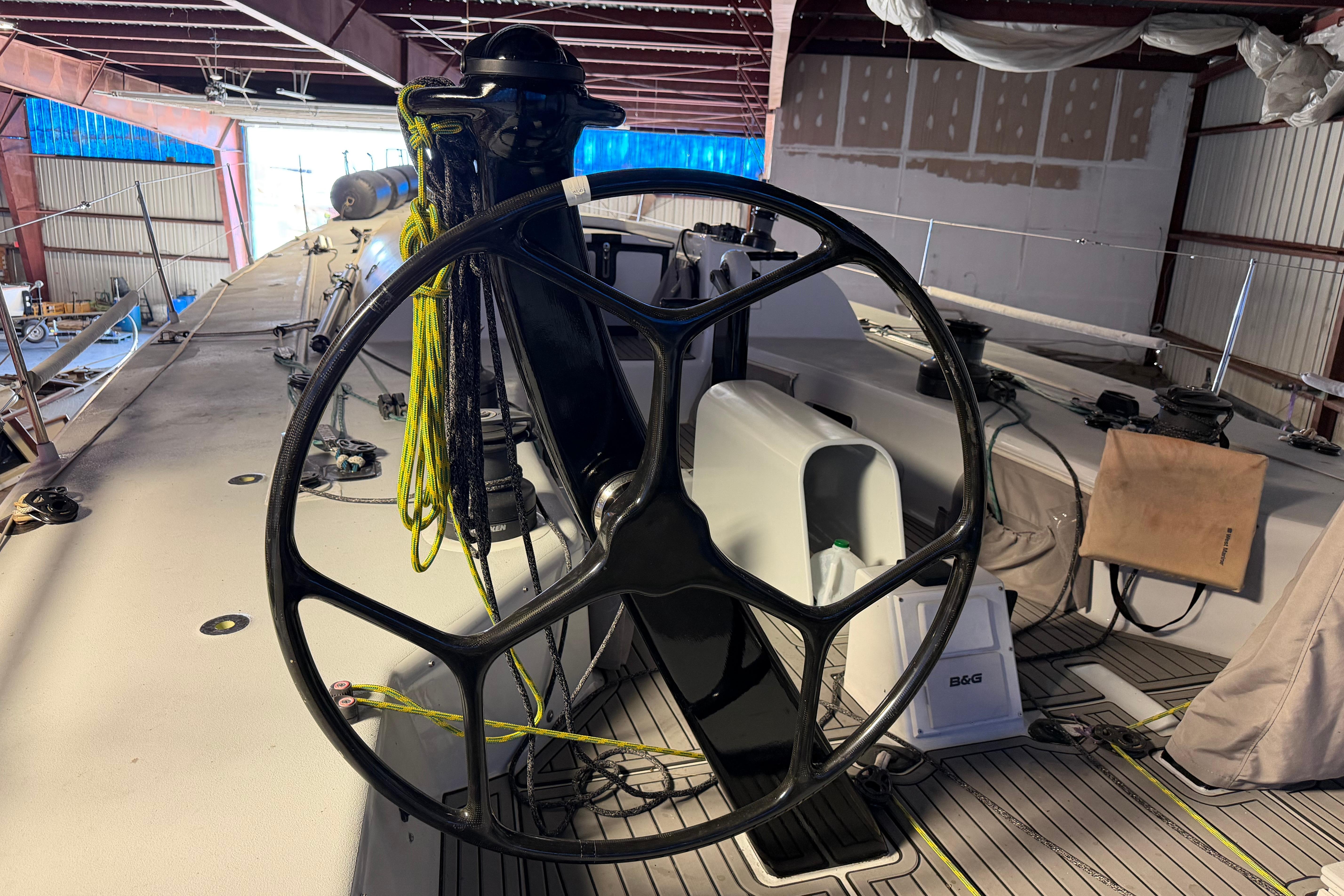 Steering wheel of Andrews 63 yacht in a boatyard setting.