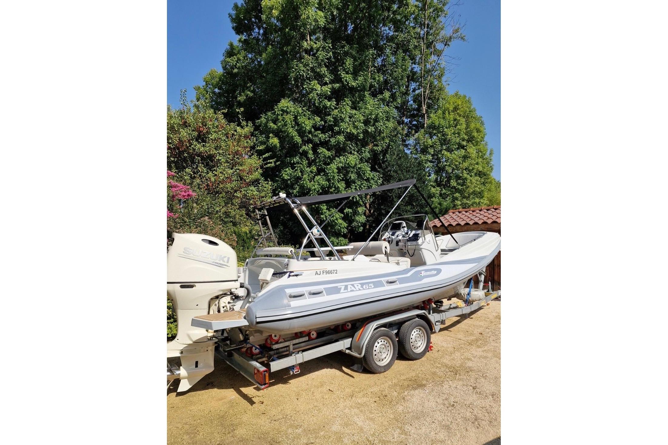 2019 Zar Formenti Zar 65 boat on trailer, surrounded by trees.