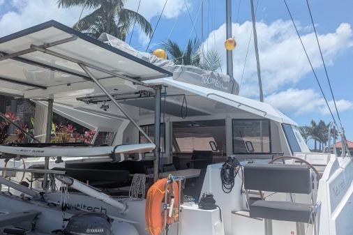 2016 Nautitech 40 Open catamaran docked under palm trees with clear blue sky.