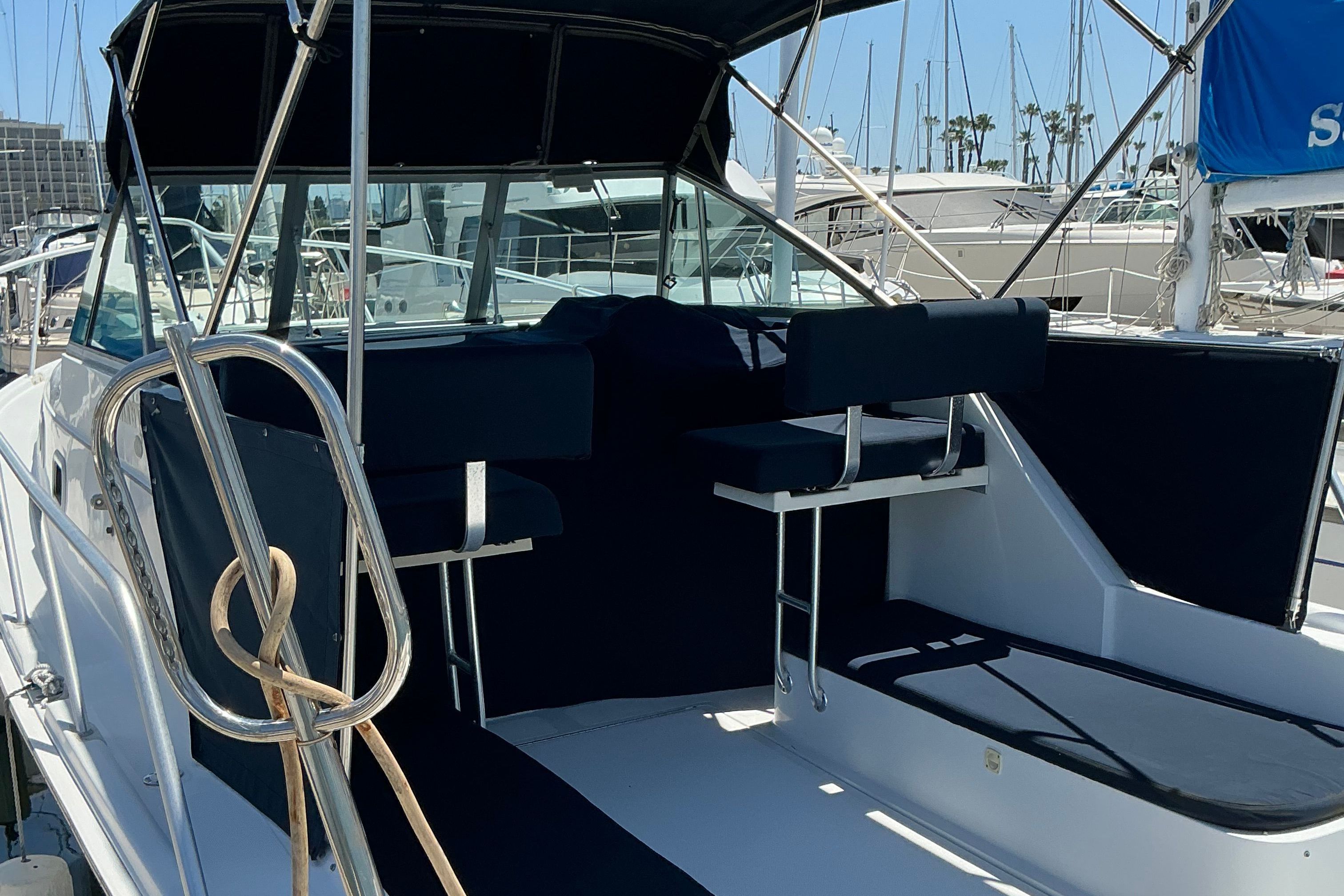 1999 Mainship Pilot 30 boat with blue upholstery in marina.