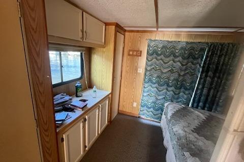 Interior of a 1995 Myacht 40X13 houseboat with wood paneling and cozy furnishings.