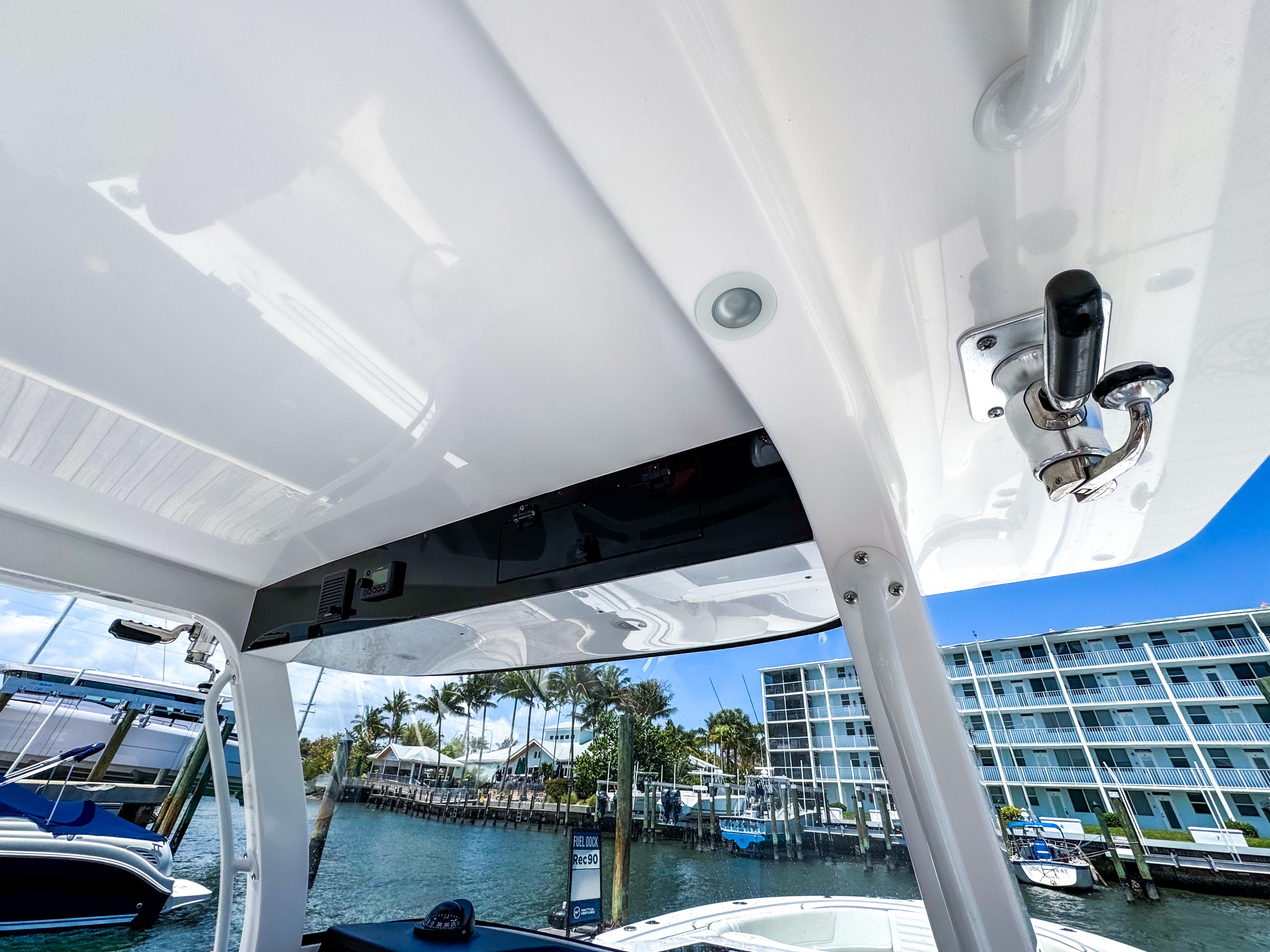 2025 Edgewater 370CC boat interior with marina view, featuring sleek design and modern amenities.