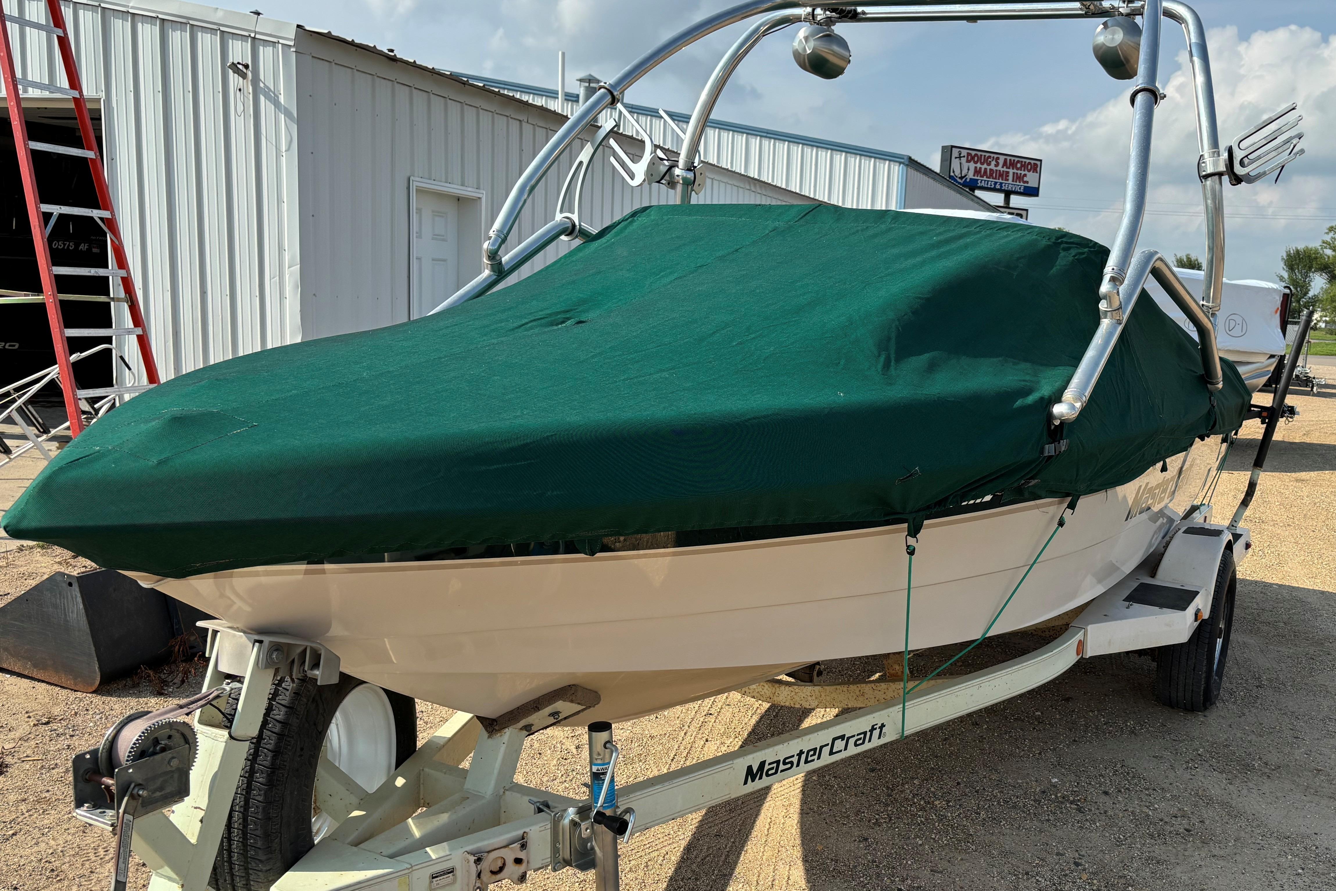 1999 MasterCraft 205 PRO STAR boat with green cover on trailer.