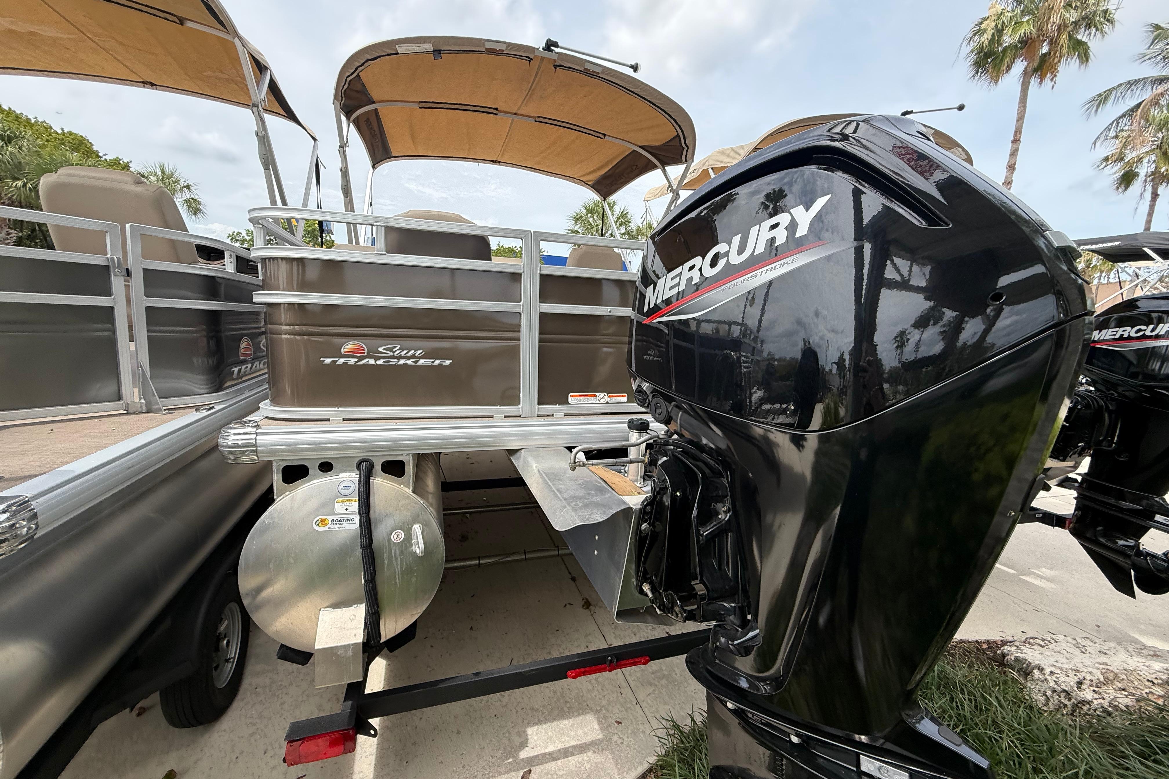 2025 Sun Tracker SportFish 20 DLX pontoon boat with Mercury outboard motor.