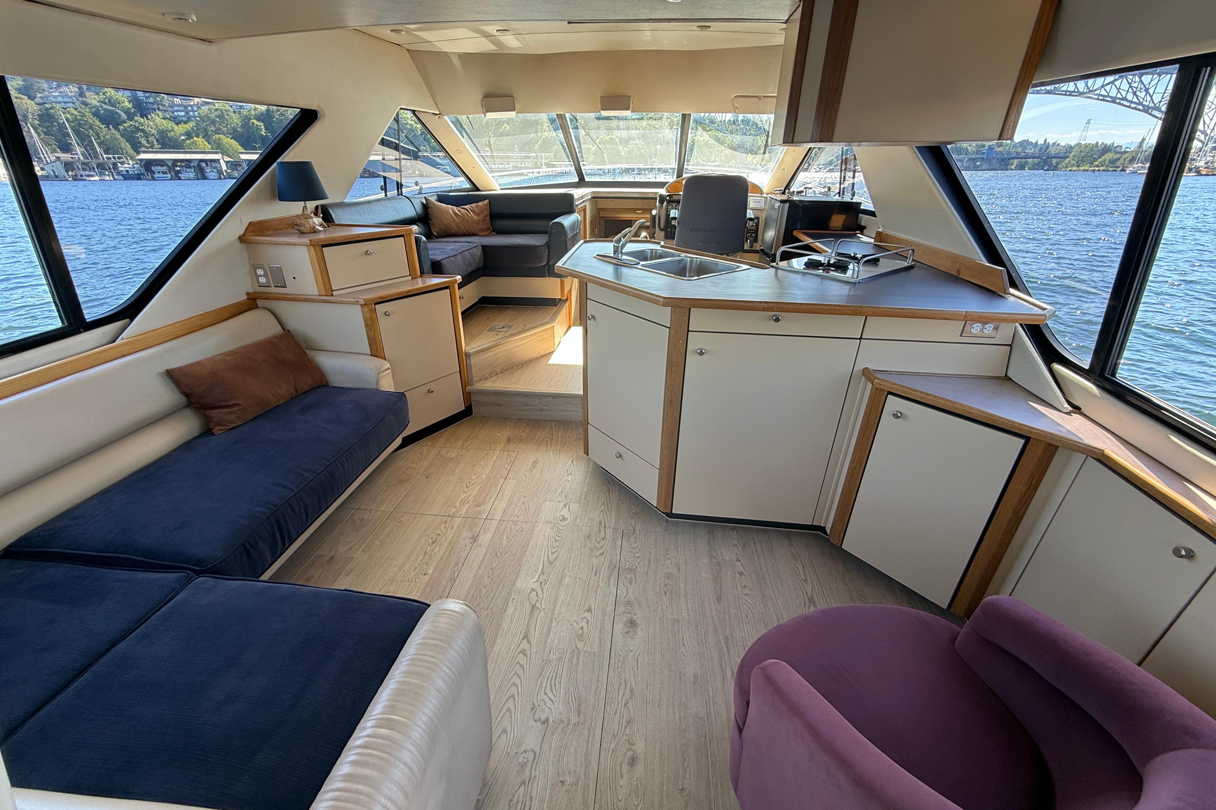 Interior of 1997 Bayliner 3988 Command Bridge Motoryacht with spacious seating and kitchen area.