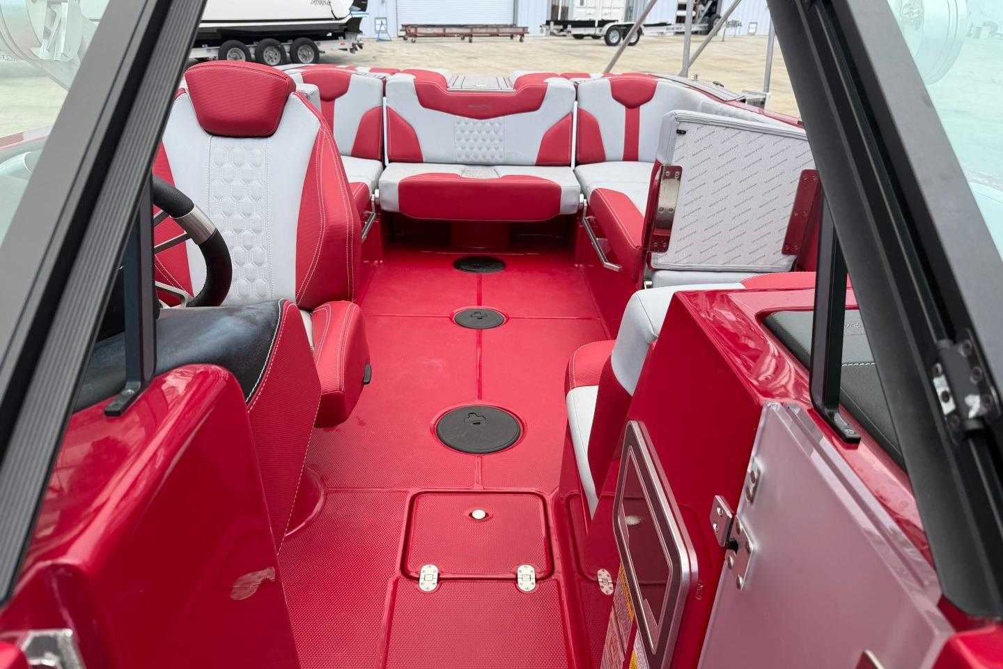 2023 MasterCraft X24 boat interior with red and white seating, modern design.