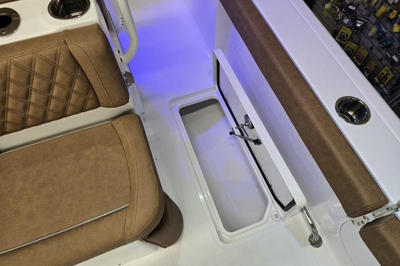 2026 Sea Hunt Ultra 275 Coffin Box interior with brown seating and storage compartment.