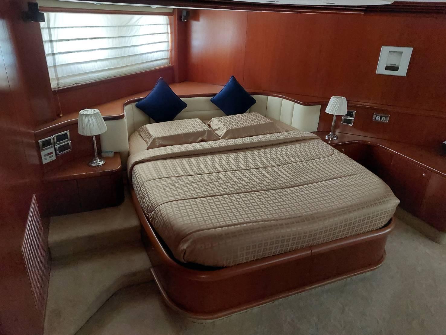 Luxurious bedroom interior of 2000 Sunseeker Predator 80 yacht with elegant bedding and decor.