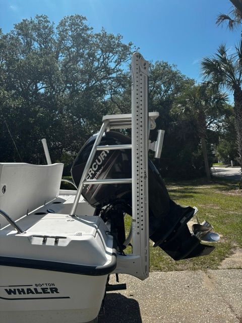 A 2008 Boston Whaler 200 Dauntless with a Mercury outboard motor, parked on a sunny lot.