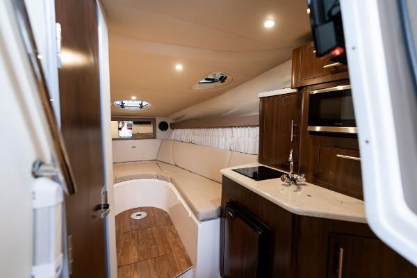 Interior of 2016 Regal 28 Express boat with kitchenette and seating area.