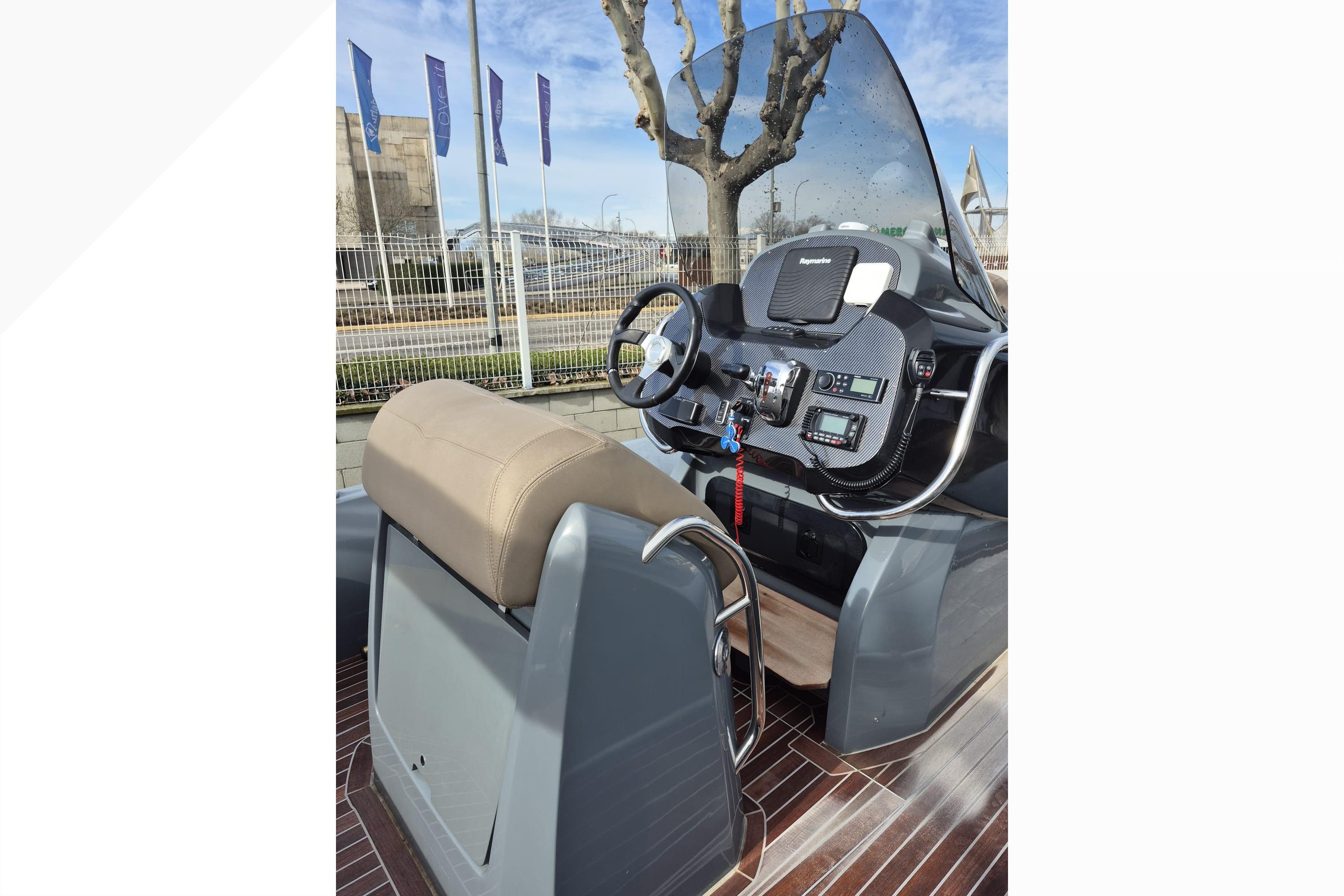 2020 SACS Strider 800 boat dashboard with steering wheel and navigation controls.