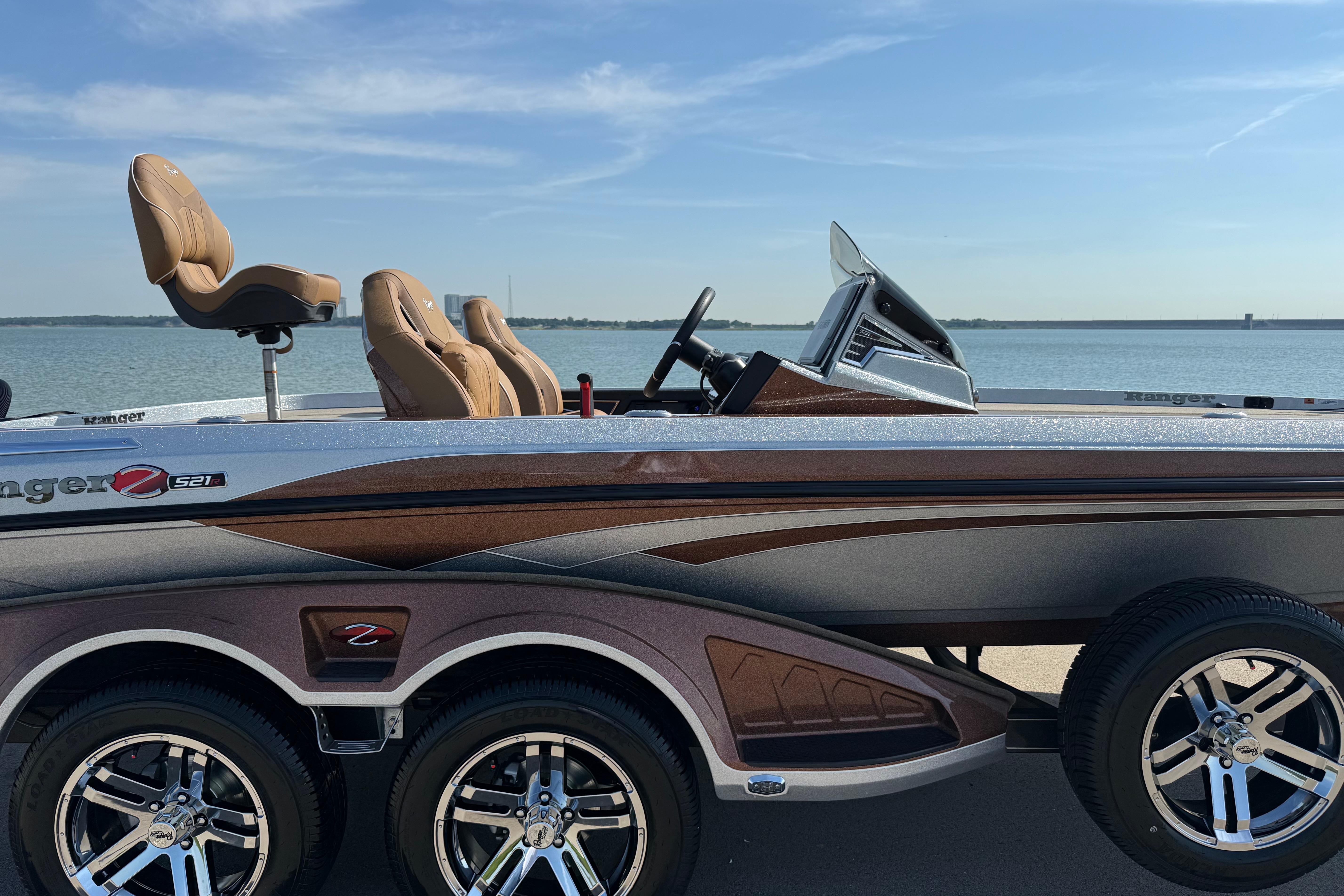 2026 Ranger Z521R boat by the water, showcasing sleek design and comfortable seating.