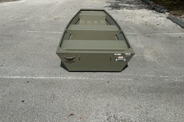 2026 Tracker Grizzly 12 Jon boat in a parking lot, showcasing its sturdy design.
