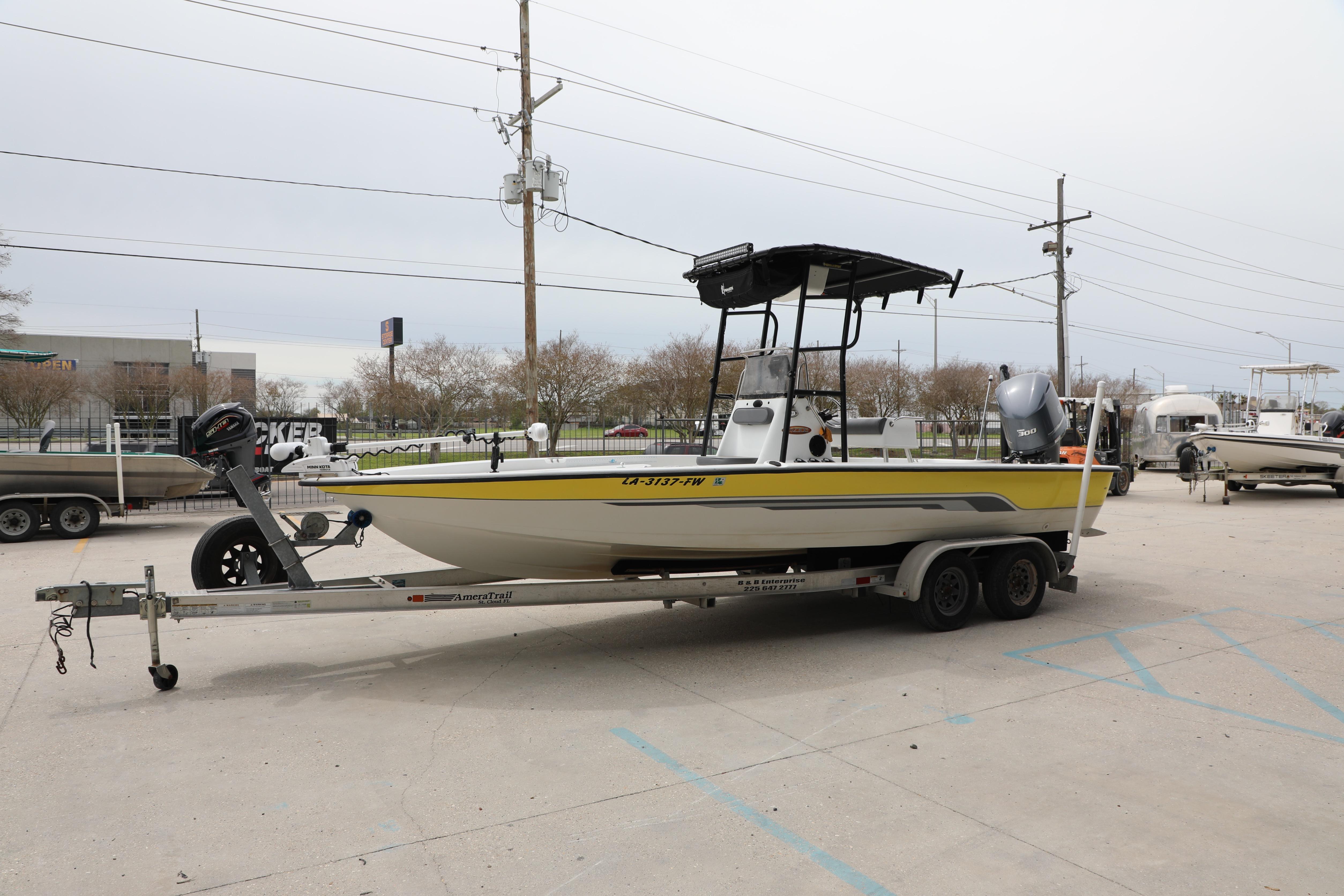 2002 Ranger 2300 Bay Ranger boat on trailer in parking lot.