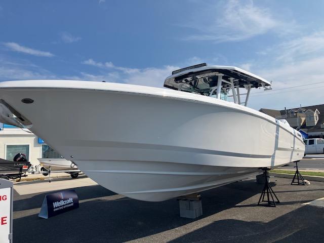 2025 Wellcraft 352 Fisherman boat displayed outdoors on stands.