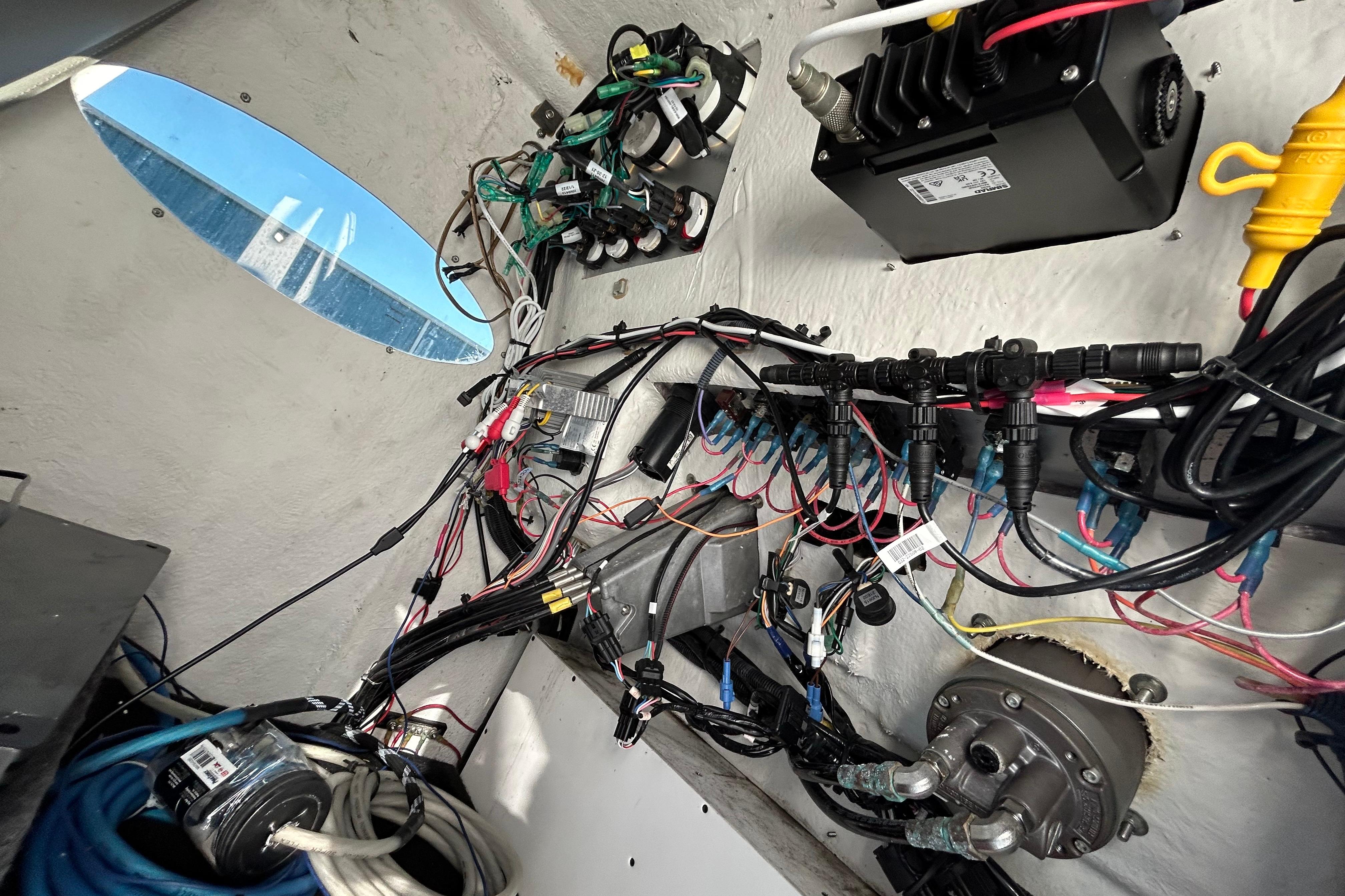 Interior wiring of a 2022 Clearwater 2300 boat, showcasing complex electrical systems.