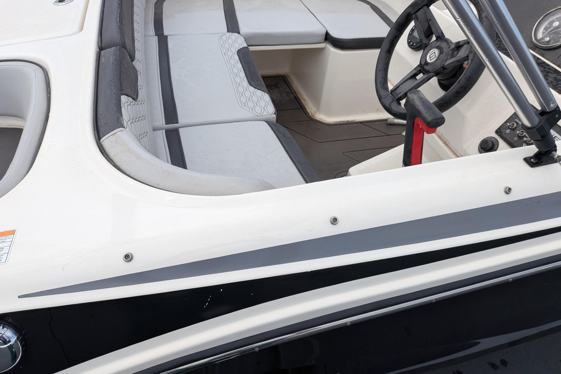 2023 Bayliner Element M17 boat interior with steering wheel and seating area.