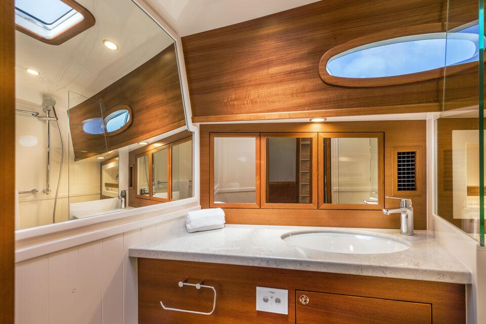 Luxurious Eastbay EB60 2026 yacht bathroom with wood accents and modern fixtures.