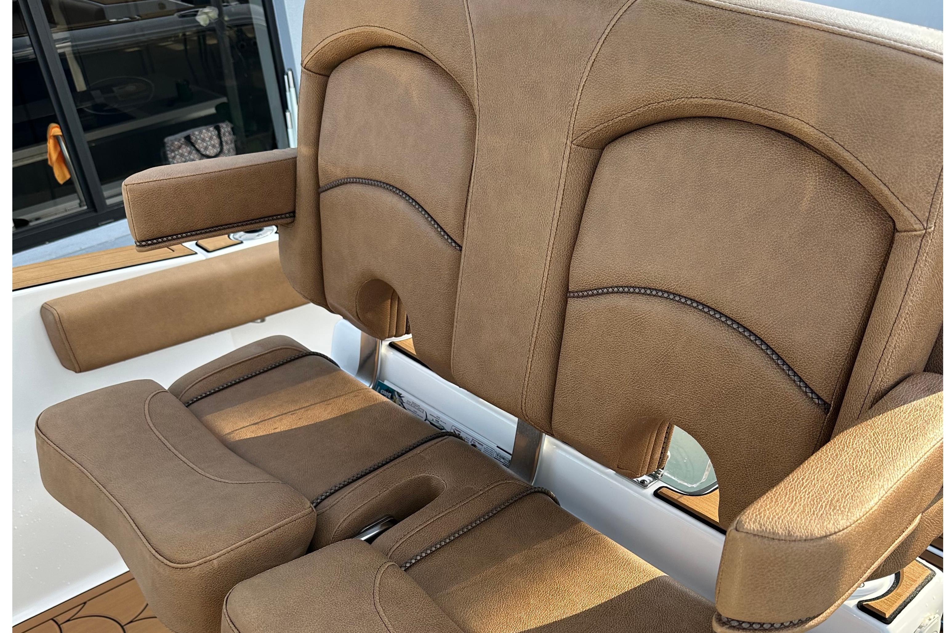 2019 Sea Hunt Gamefish 25 boat seats with brown upholstery and armrests.