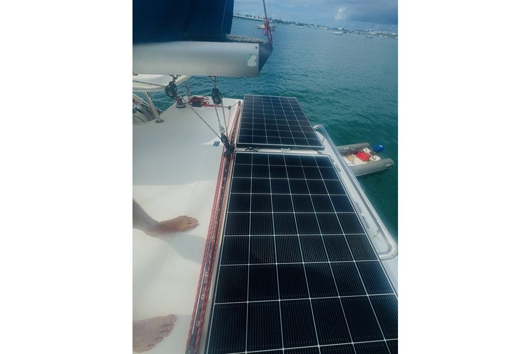 Solar panels on a 2011 Leopard 39 catamaran, docked in a serene harbor.