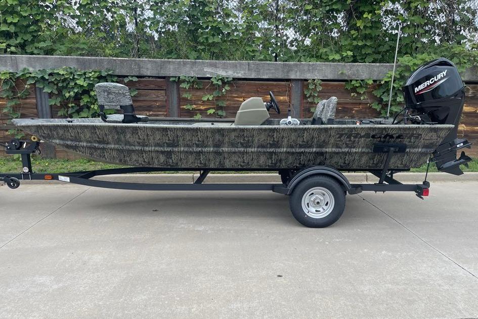 2026 Tracker Grizzly 1754 SC boat on trailer, camo design, Mercury outboard motor.