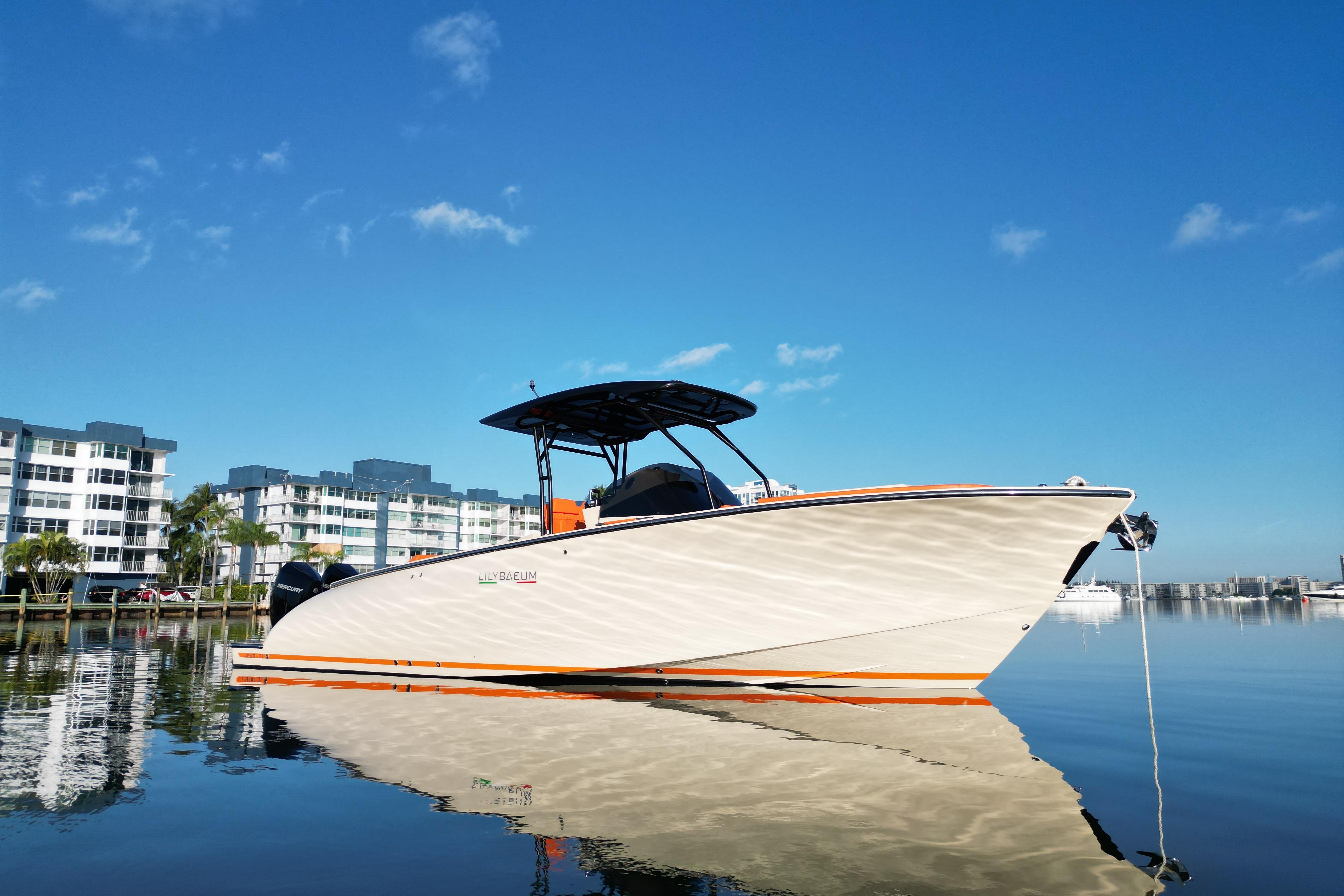 2026 Lilybaeum Lipari 31 boat docked on calm water, modern buildings in background.