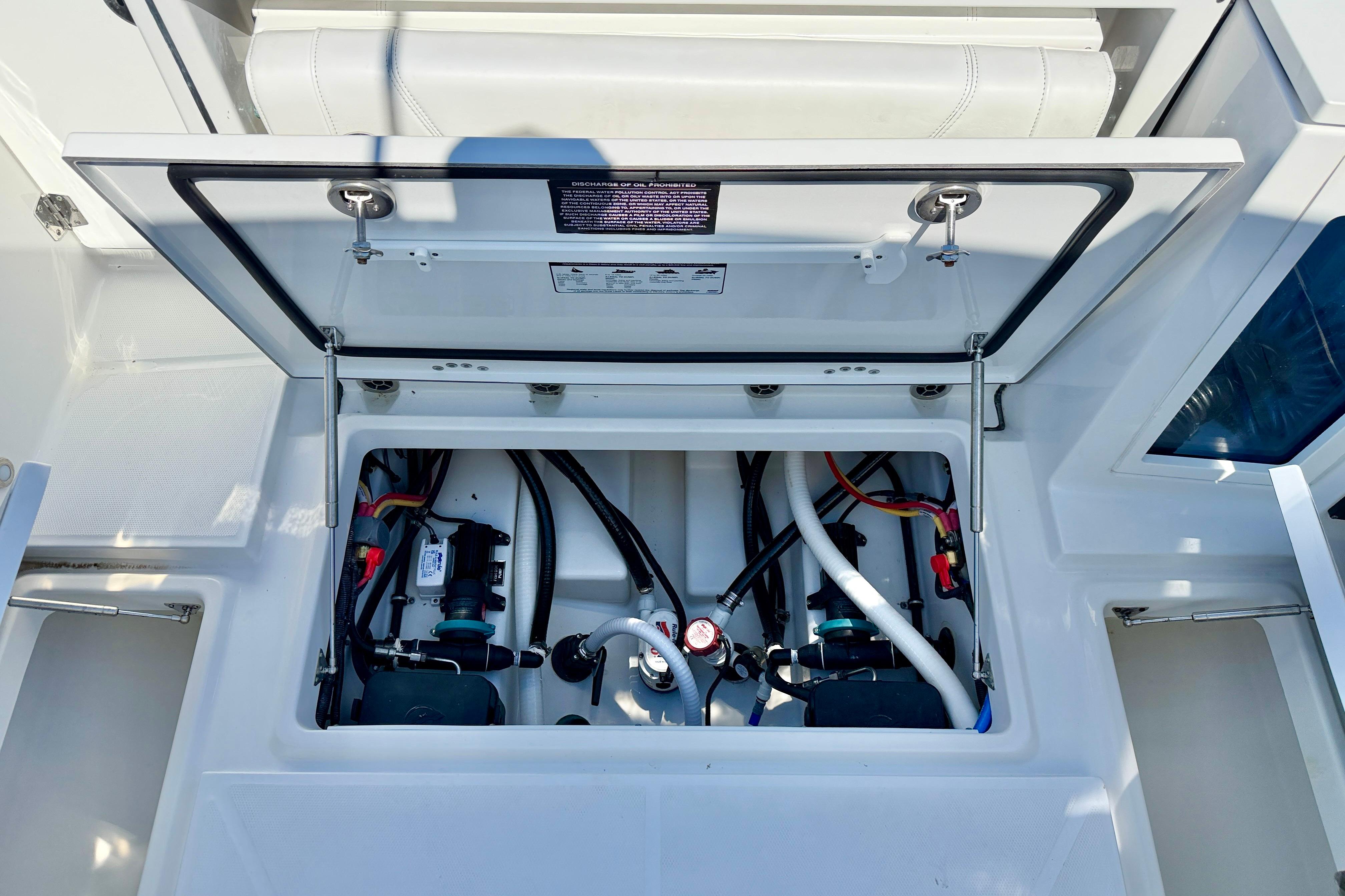 Open hatch of 2023 Blackfin 272 DC boat showing internal components and wiring.