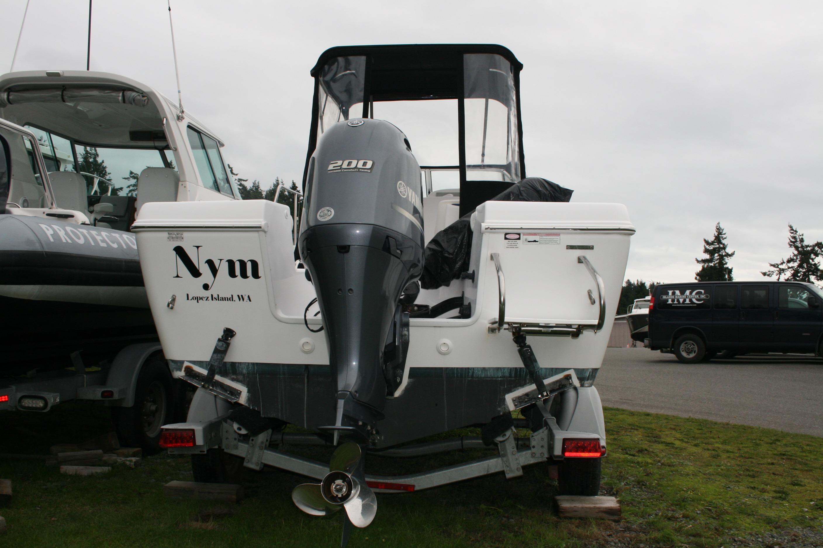 2013 Pro-Line 20 Express boat with Yamaha 200 engine, parked on grass.