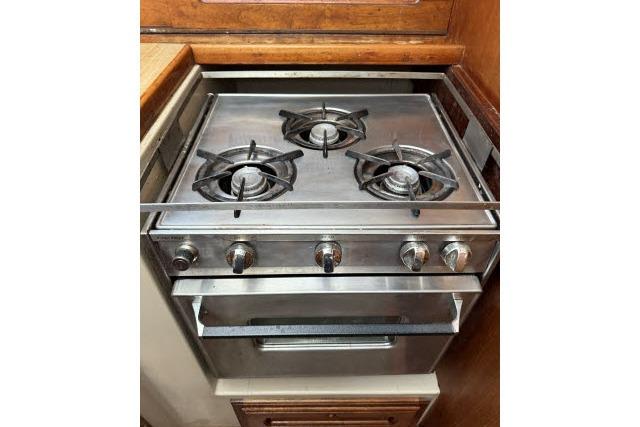 Stainless steel stove with three burners in a 1982 Lancer 45 Motorsailer kitchen.