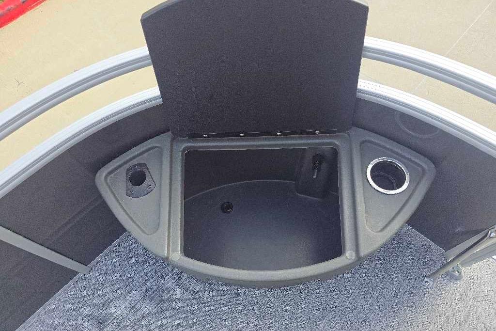 2026 Sun Tracker Fishin' Barge 20 DLX boat interior with storage and cup holder.