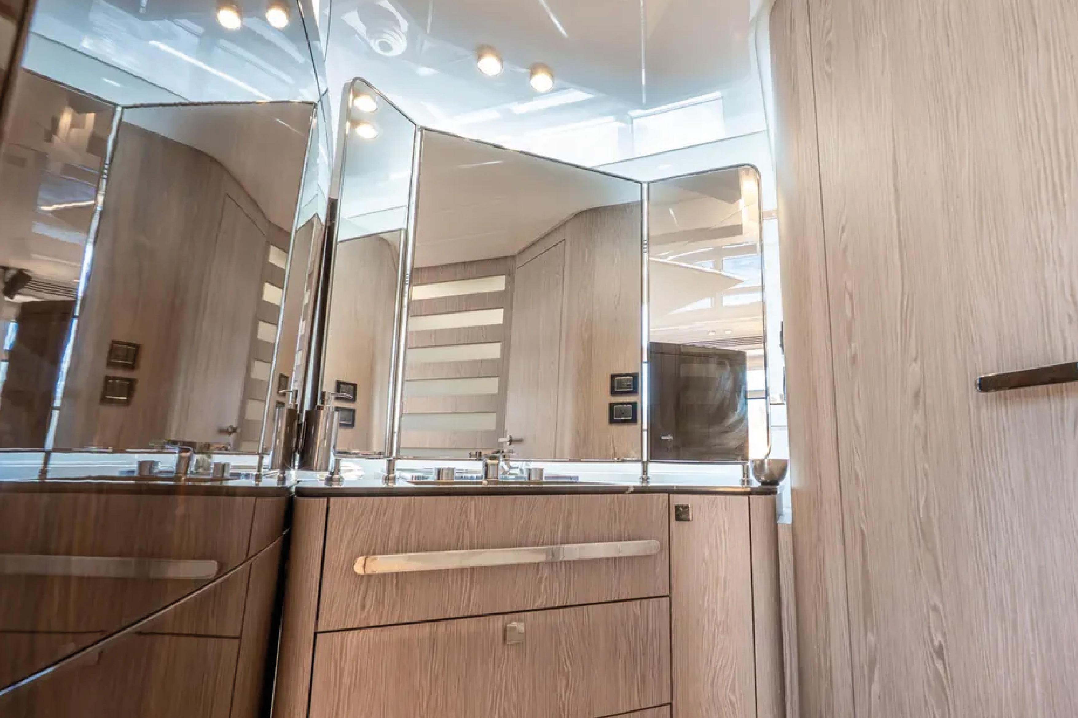 Luxurious bathroom interior of 2019 Azimut S7 yacht with modern fixtures and wood finish.